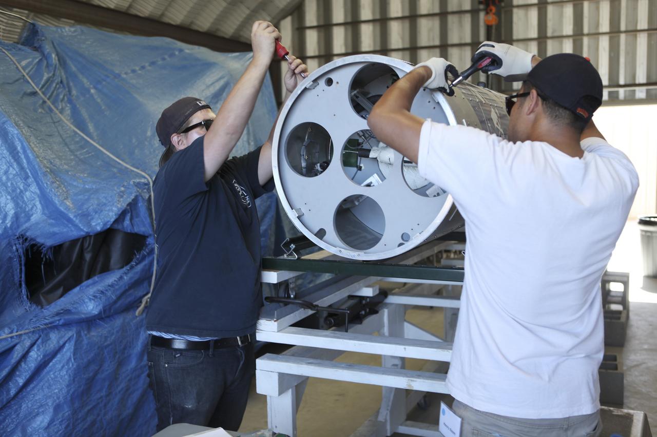 MOJAVE DESERT, Calif. – In the Mojave Desert in California, students and engineers checkout the Garvey Spacecraft Corporation's Prospector P-18D rocket scheduled for launch June 15 with the RUBICS-1 payload on a high-altitude, suborbital flight. The rocket will carry four satellites made from four-inch cube section. Collectively known as CubeSats, the satellites will record shock, vibrations and heat inside the rocket. They will not be released during the test flight, but the results will be used to prove or strengthen their designs before they are carried into orbit in 2014 on a much larger rocket. A new, lightweight carrier is also being tested for use on future missions to deploy the small spacecraft. The flight also is being watched closely as a model for trying out new or off-the-shelf technologies quickly before putting them in the pipeline for use on NASA's largest launchers. Built by several different organizations, including a university, a NASA field center and a high school, the spacecraft are four-inch cubes designed to fly on their own eventually, but will remain firmly attached to the rocket during the upcoming mission. For more information, visit http://www.nasa.gov/mission_pages/smallsats/elana/cubesatlaunchpreview.html Photo credit: NASA/Dimitri Gerondidakis