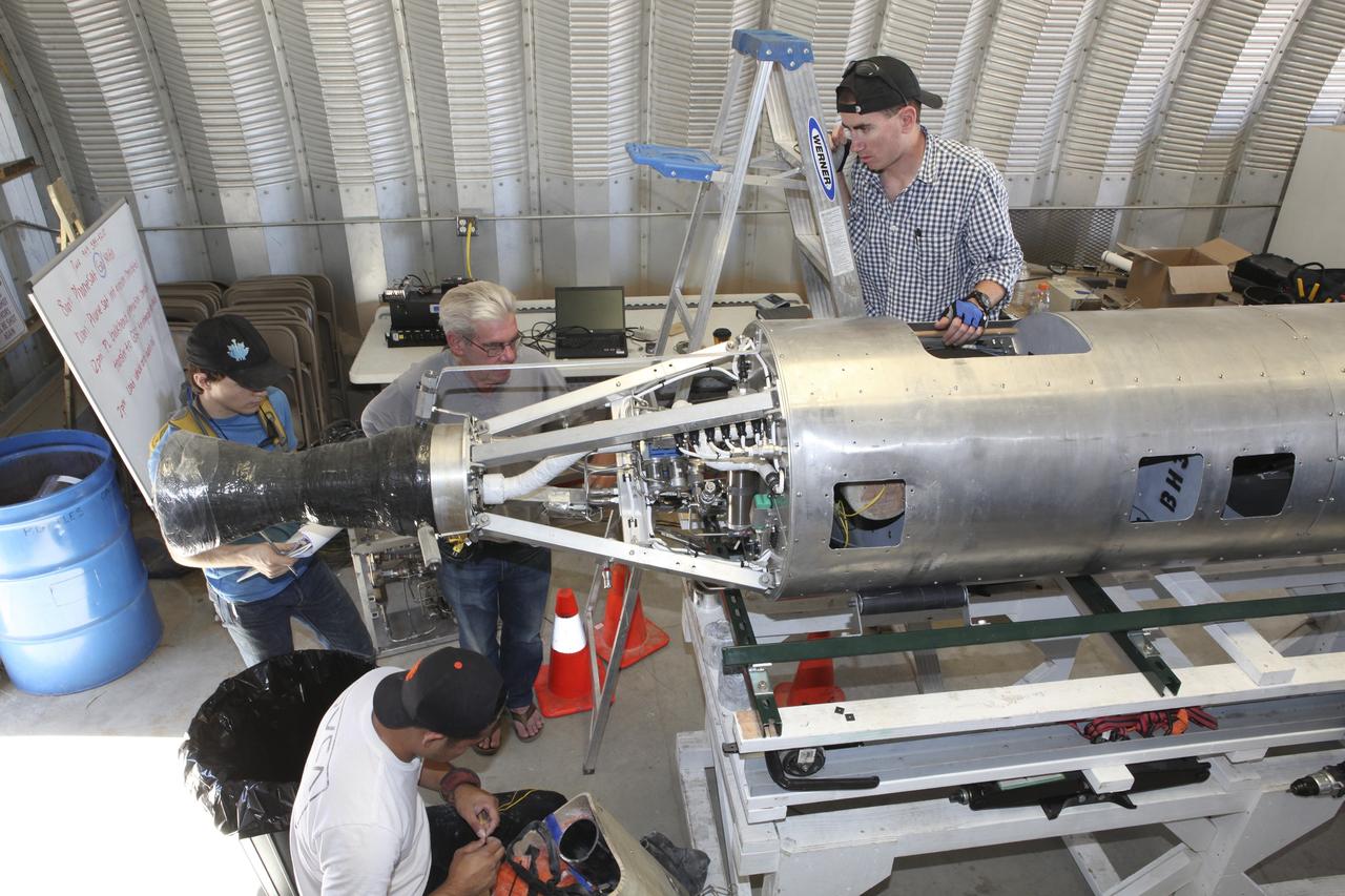 In the Mojave Desert in California, students and engineers checkout the Garvey Spacecraft Corporation's Prospector P-18D rocket engine. The rocket is scheduled for launch June 15 with the RUBICS-1 payload on a high-altitude, suborbital flight. The rocket will carry four satellites made from four-inch cube section.      Collectively known as CubeSats, the satellites will record shock, vibrations and heat inside the rocket. They will not be released during the test flight, but the results will be used to prove or strengthen their designs before they are carried into orbit in 2014 on a much larger rocket. A new, lightweight carrier is also being tested for use on future missions to deploy the small spacecraft. The flight also is being watched closely as a model for trying out new or off-the-shelf technologies quickly before putting them in the pipeline for use on NASA's largest launchers.  Built by several different organizations, including a university, a NASA field center and a high school, the spacecraft are four-inch cubes designed to fly on their own eventually, but will remain firmly attached to the rocket during the upcoming mission. For more information, visit http://www.nasa.gov/mission_pages/smallsats/elana/cubesatlaunchpreview.html Photo credit: NASA/Dimitri Gerondidakis