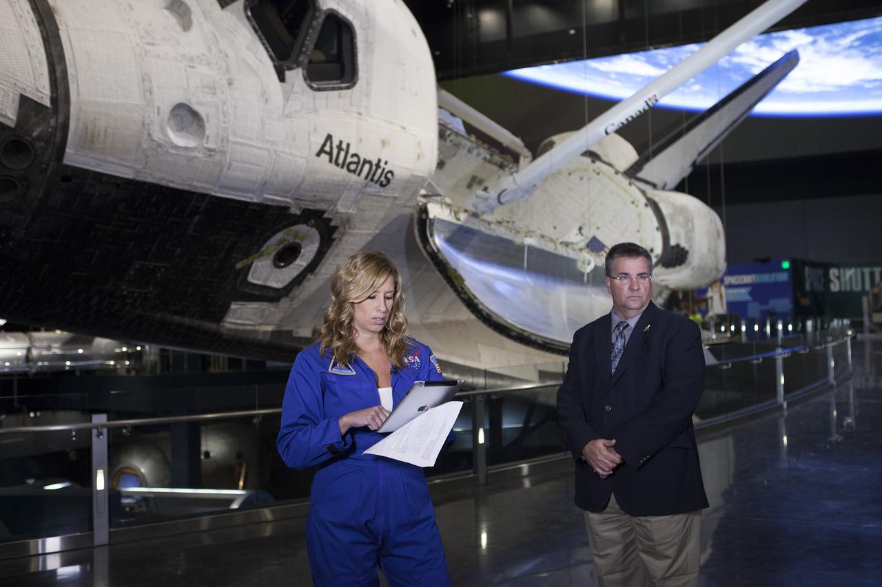 CAPE CANAVERAL, Fla. - Stephanie Abrams, a meteorologist with The Weather Channel, prepares for a live interview with Ed Mango, manager of NASA's Commercial Crew Program, or CCP, in front of the Atlantis display at the Kennedy Space Center Visitor Complex in Florida. During the interview, Mango explained the program is working with the commercial aerospace industry to return America's domestic capability to launch astronauts from U.S. soil to the International Space Station around the middle of the decade. He also discussed the program's role in helping NASA reach its deep-space exploration goals. To learn more about CCP, visit www.nasa.gov/commercialcrew. Photo credit: Kim Shiflett