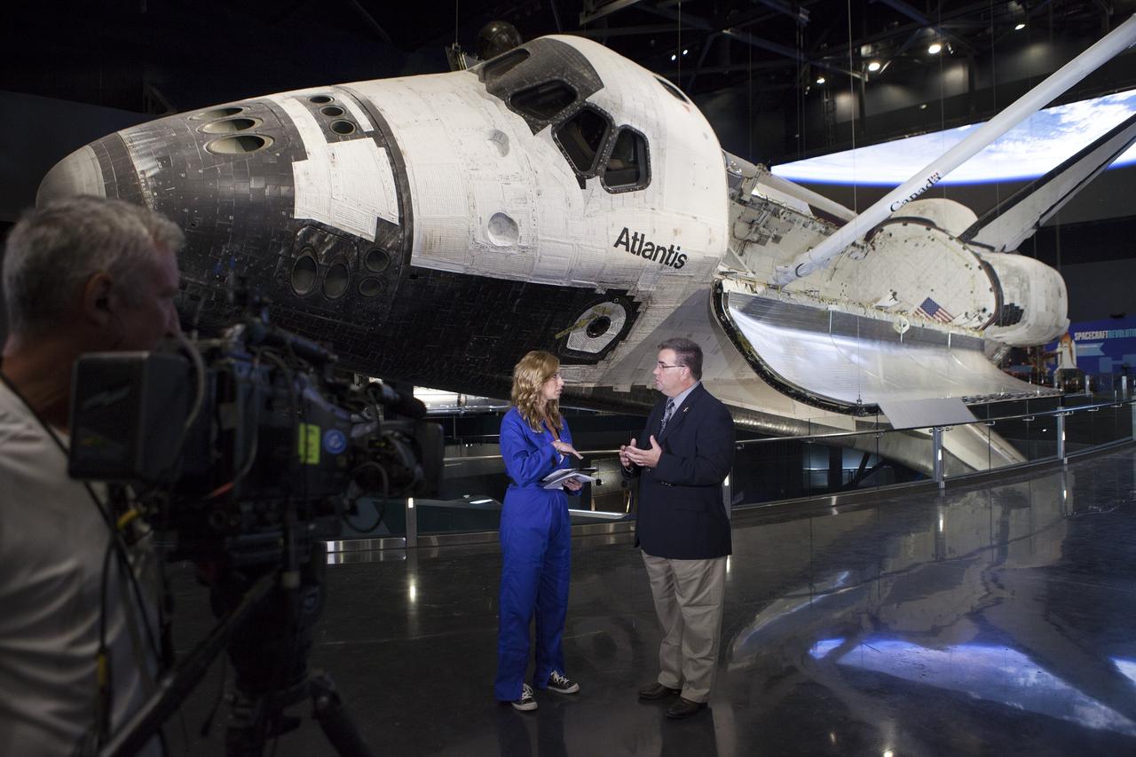 CAPE CANAVERAL, Fla. - Stephanie Abrams, a meteorologist with The Weather Channel, performs a live interview with Ed Mango, manager of NASA's Commercial Crew Program, or CCP, in front of the Atlantis display at the Kennedy Space Center Visitor Complex in Florida. Mango explained the program is working with the commercial aerospace industry to return America's domestic capability to launch astronauts from U.S. soil to the International Space Station around the middle of the decade. He also discussed the program's role in helping NASA reach its deep-space exploration goals. To learn more about CCP, visit www.nasa.gov/commercialcrew. Photo credit: Kim Shiflett