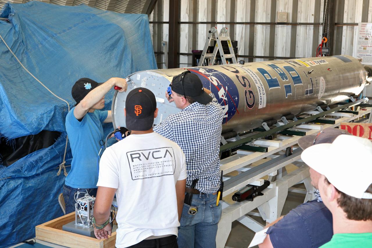 MOJAVE DESERT, Calif. – In the Mojave Desert in California, students and engineers checkout the Garvey Spacecraft Corporation's Prospector P-18D rocket. The rocket is scheduled for launch June 15 with the RUBICS-1 payload on a high-altitude, suborbital flight. The rocket will carry four satellites made from four-inch cube sections. Collectively known as CubeSats, the satellites will record shock, vibrations and heat inside the rocket. They will not be released during the test flight, but the results will be used to prove or strengthen their designs before they are carried into orbit in 2014 on a much larger rocket. A new, lightweight carrier is also being tested for use on future missions to deploy the small spacecraft. The flight also is being watched closely as a model for trying out new or off-the-shelf technologies quickly before putting them in the pipeline for use on NASA's largest launchers. Built by several different organizations, including a university, a NASA field center and a high school, the spacecraft are four-inch cubes designed to fly on their own eventually, but will remain firmly attached to the rocket during the upcoming mission. For more information, visit http://www.nasa.gov/mission_pages/smallsats/elana/cubesatlaunchpreview.html Photo credit: NASA/Dimitri Gerondidakis