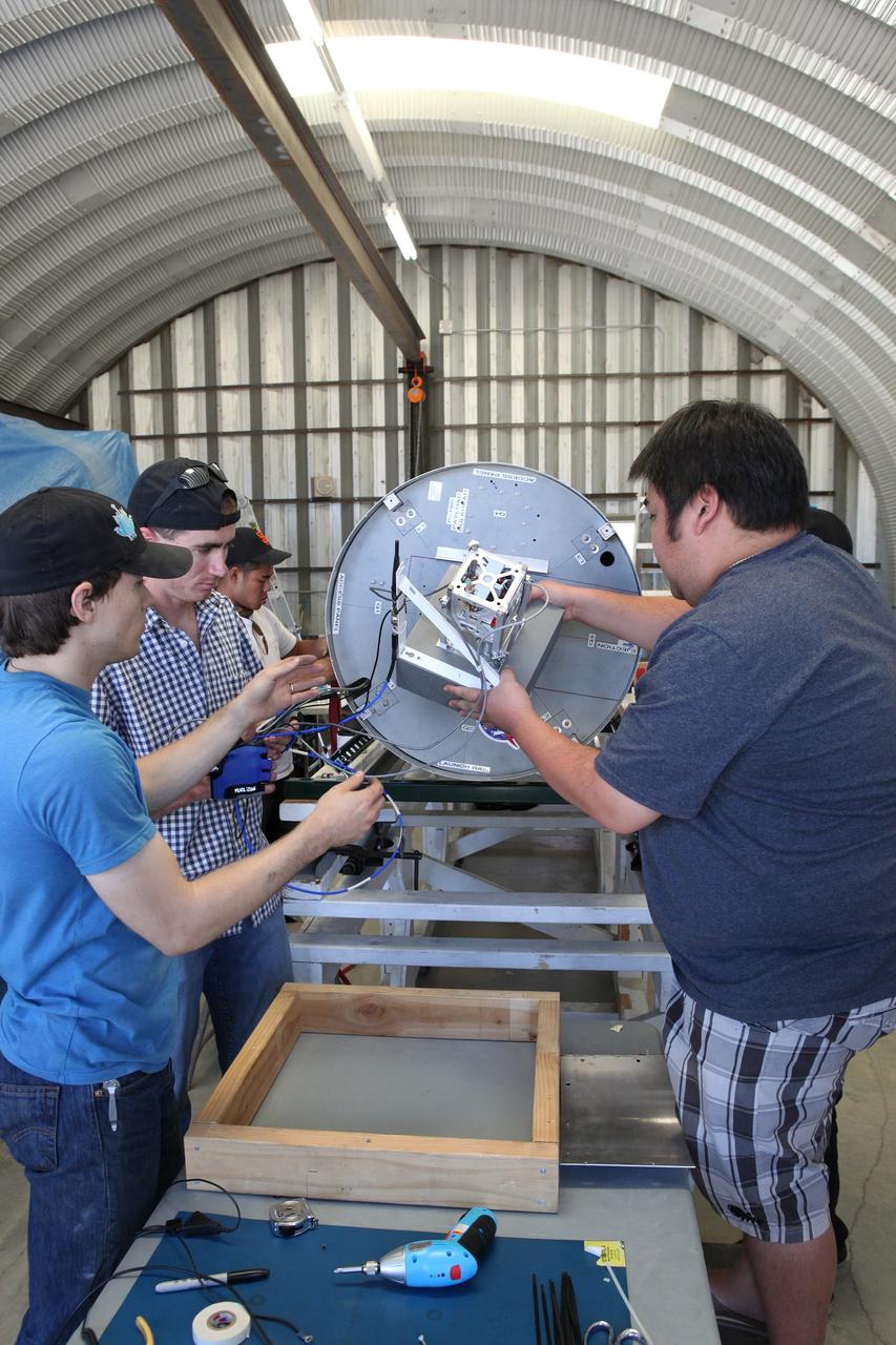 MOJAVE DESERT, Calif. – In the Mojave Desert in California, students and engineers checkout the Garvey Spacecraft Corporation's Prospector P-18D rocket. The rocket is scheduled for launch June 15 with the RUBICS-1 payload on a high-altitude, suborbital flight. The rocket will carry four satellites made from four-inch cube sections. Collectively known as CubeSats, the satellites will record shock, vibrations and heat inside the rocket. They will not be released during the test flight, but the results will be used to prove or strengthen their designs before they are carried into orbit in 2014 on a much larger rocket. A new, lightweight carrier is also being tested for use on future missions to deploy the small spacecraft. The flight also is being watched closely as a model for trying out new or off-the-shelf technologies quickly before putting them in the pipeline for use on NASA's largest launchers. Built by several different organizations, including a university, a NASA field center and a high school, the spacecraft are four-inch cubes designed to fly on their own eventually, but will remain firmly attached to the rocket during the upcoming mission. For more information, visit http://www.nasa.gov/mission_pages/smallsats/elana/cubesatlaunchpreview.html Photo credit: NASA/Dimitri Gerondidakis