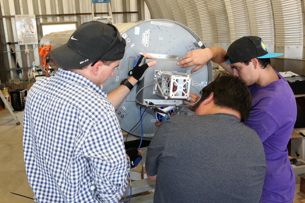 MOJAVE DESERT, Calif. – In the Mojave Desert in California, students and engineers checkout the Garvey Spacecraft Corporation's Prospector P-18D rocket. The rocket is scheduled for launch June 15 with the RUBICS-1 payload on a high-altitude, suborbital flight. The rocket will carry four satellites made from four-inch cube sections. Collectively known as CubeSats, the satellites will record shock, vibrations and heat inside the rocket. They will not be released during the test flight, but the results will be used to prove or strengthen their designs before they are carried into orbit in 2014 on a much larger rocket. A new, lightweight carrier is also being tested for use on future missions to deploy the small spacecraft. The flight also is being watched closely as a model for trying out new or off-the-shelf technologies quickly before putting them in the pipeline for use on NASA's largest launchers. Built by several different organizations, including a university, a NASA field center and a high school, the spacecraft are four-inch cubes designed to fly on their own eventually, but will remain firmly attached to the rocket during the upcoming mission. For more information, visit http://www.nasa.gov/mission_pages/smallsats/elana/cubesatlaunchpreview.html Photo credit: NASA/Dimitri Gerondidakis