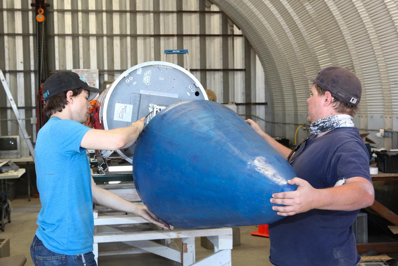 MOJAVE DESERT, Calif. – In the Mojave Desert in California, students install the nose cone on the Garvey Spacecraft Corporation's Prospector P-18D rocket. The work is in preparation for the June 15 launch on a high-altitude, suborbital flight. The rocket will carry four satellites made from four-inch cube sections. Collectively known as CubeSats, the satellites will record shock, vibrations and heat inside the rocket. They will not be released during the test flight, but the results will be used to prove or strengthen their designs before they are carried into orbit in 2014 on a much larger rocket. A new, lightweight carrier is also being tested for use on future missions to deploy the small spacecraft. The flight also is being watched closely as a model for trying out new or off-the-shelf technologies quickly before putting them in the pipeline for use on NASA's largest launchers. Built by several different organizations, including a university, a NASA field center and a high school, the spacecraft are four-inch cubes designed to fly on their own eventually, but will remain firmly attached to the rocket during the upcoming mission. For more information, visit http://www.nasa.gov/mission_pages/smallsats/elana/cubesatlaunchpreview.html Photo credit: NASA/Dimitri Gerondidakis