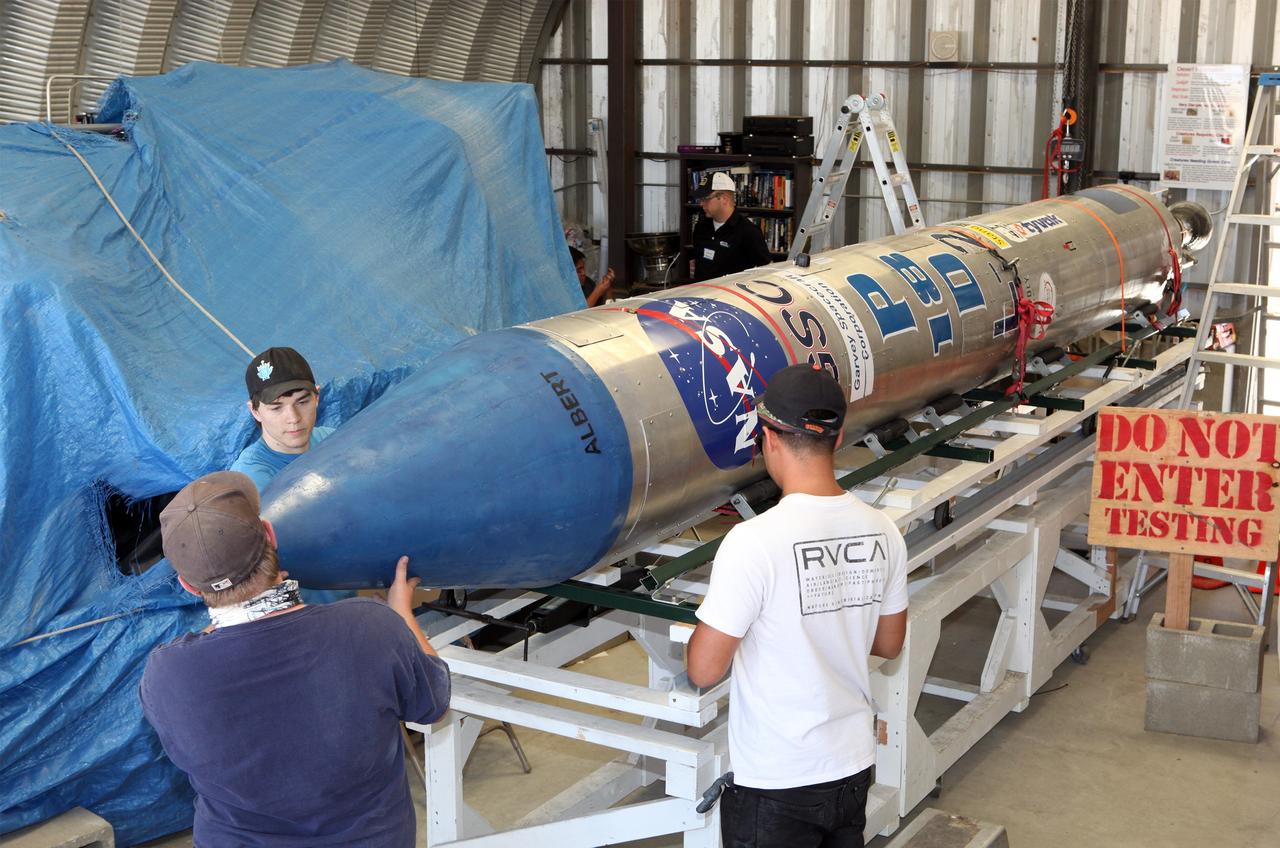 MOJAVE DESERT, Calif. – In the Mojave Desert in California, students install the nose cone on the Garvey Spacecraft Corporation's Prospector P-18D rocket. The work is in preparation for the June 15 launch on a high-altitude, suborbital flight. The rocket will carry four satellites made from four-inch cube sections. Collectively known as CubeSats, the satellites will record shock, vibrations and heat inside the rocket. They will not be released during the test flight, but the results will be used to prove or strengthen their designs before they are carried into orbit in 2014 on a much larger rocket. A new, lightweight carrier is also being tested for use on future missions to deploy the small spacecraft. The flight also is being watched closely as a model for trying out new or off-the-shelf technologies quickly before putting them in the pipeline for use on NASA's largest launchers. Built by several different organizations, including a university, a NASA field center and a high school, the spacecraft are four-inch cubes designed to fly on their own eventually, but will remain firmly attached to the rocket during the upcoming mission. For more information, visit http://www.nasa.gov/mission_pages/smallsats/elana/cubesatlaunchpreview.html Photo credit: NASA/Dimitri Gerondidakis