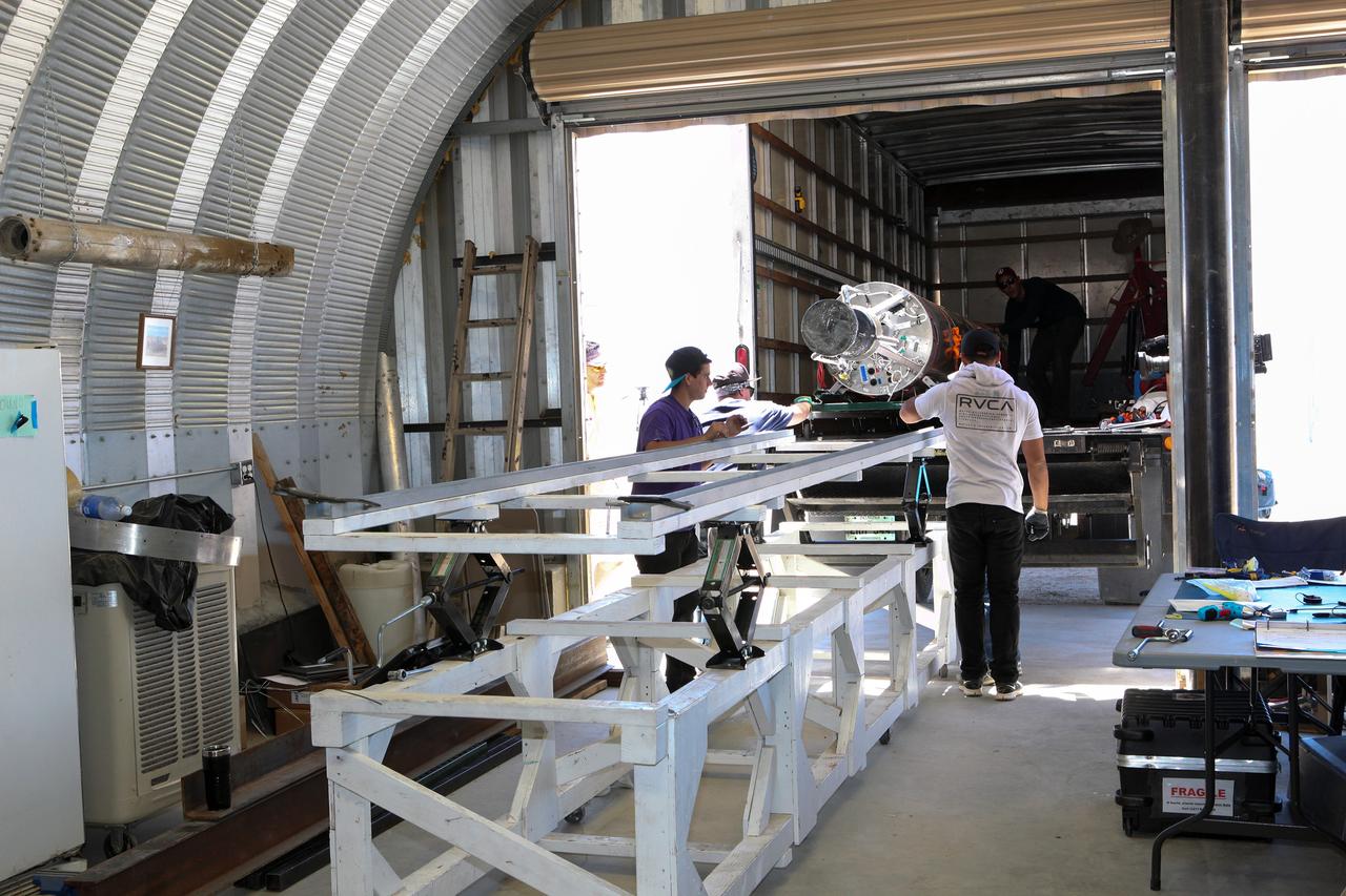 MOJAVE DESERT, Calif. – In the Mojave Desert in California, students and engineers load the Garvey Spacecraft Corporation's Prospector P-18D rocket onto a truck for transportation to the launch site. The rocket is scheduled for launch June 15 with the RUBICS-1 payload on a high-altitude, suborbital flight. The rocket will carry four satellites made from four-inch cube sections. Collectively known as CubeSats, the satellites will record shock, vibrations and heat inside the rocket. They will not be released during the test flight, but the results will be used to prove or strengthen their designs before they are carried into orbit in 2014 on a much larger rocket. A new, lightweight carrier is also being tested for use on future missions to deploy the small spacecraft. The flight also is being watched closely as a model for trying out new or off-the-shelf technologies quickly before putting them in the pipeline for use on NASA's largest launchers. Built by several different organizations, including a university, a NASA field center and a high school, the spacecraft are four-inch cubes designed to fly on their own eventually, but will remain firmly attached to the rocket during the upcoming mission. For more information, visit http://www.nasa.gov/mission_pages/smallsats/elana/cubesatlaunchpreview.html Photo credit: NASA/Dimitri Gerondidakis
