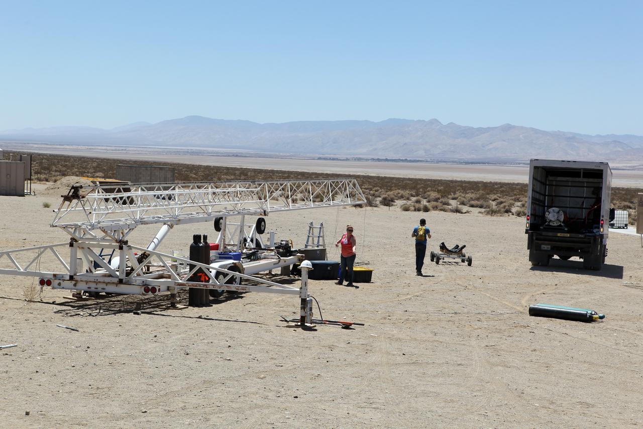 MOJAVE DESERT, Calif. – In the Mojave Desert in California, students and engineers prepare the launch stand for the Garvey Spacecraft Corporation's Prospector P-18D rocket. The rocket is scheduled for launch June 15 with the RUBICS-1 payload on a high-altitude, suborbital flight. The rocket will carry four satellites made from four-inch cube sections. Collectively known as CubeSats, the satellites will record shock, vibrations and heat inside the rocket. They will not be released during the test flight, but the results will be used to prove or strengthen their designs before they are carried into orbit in 2014 on a much larger rocket. A new, lightweight carrier is also being tested for use on future missions to deploy the small spacecraft. The flight also is being watched closely as a model for trying out new or off-the-shelf technologies quickly before putting them in the pipeline for use on NASA's largest launchers. Built by several different organizations, including a university, a NASA field center and a high school, the spacecraft are four-inch cubes designed to fly on their own eventually, but will remain firmly attached to the rocket during the upcoming mission. For more information, visit http://www.nasa.gov/mission_pages/smallsats/elana/cubesatlaunchpreview.html Photo credit: NASA/Dimitri Gerondidakis