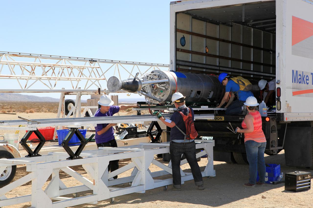 MOJAVE DESERT, Calif. – In the Mojave Desert in California, students and engineers unload the Garvey Spacecraft Corporation's Prospector P-18D rocket from a truck at the launch site. The rocket is scheduled for launch June 15 with the RUBICS-1 payload on a high-altitude, suborbital flight. The rocket will carry four satellites made from four-inch cube sections. Collectively known as CubeSats, the satellites will record shock, vibrations and heat inside the rocket. They will not be released during the test flight, but the results will be used to prove or strengthen their designs before they are carried into orbit in 2014 on a much larger rocket. A new, lightweight carrier is also being tested for use on future missions to deploy the small spacecraft. The flight also is being watched closely as a model for trying out new or off-the-shelf technologies quickly before putting them in the pipeline for use on NASA's largest launchers. Built by several different organizations, including a university, a NASA field center and a high school, the spacecraft are four-inch cubes designed to fly on their own eventually, but will remain firmly attached to the rocket during the upcoming mission. For more information, visit http://www.nasa.gov/mission_pages/smallsats/elana/cubesatlaunchpreview.html Photo credit: NASA/Dimitri Gerondidakis