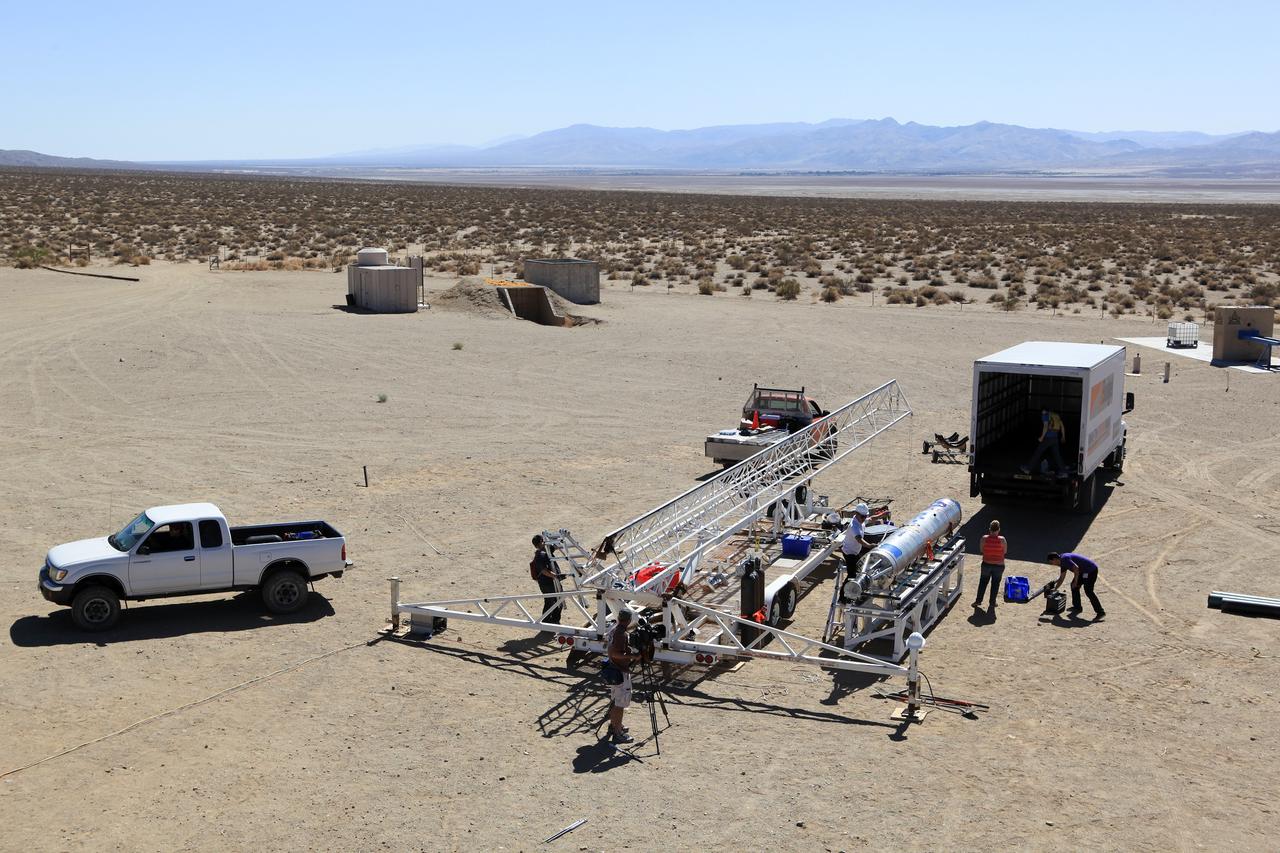 MOJAVE DESERT, Calif. – In the Mojave Desert in California, students and engineers checkout the Garvey Spacecraft Corporation's Prospector P-18D rocket at the Friends of Amateur Rocketry launch site. The rocket is scheduled for launch June 15 with the RUBICS-1 payload on a high-altitude, suborbital mission. The rocket will carry four satellites made from four-inch cube sections. Collectively known as CubeSats, the satellites will record shock, vibrations and heat inside the rocket. They will not be released during the test flight, but the results will be used to prove or strengthen their designs before they are carried into orbit in 2014 on a much larger rocket. A new, lightweight carrier is also being tested for use on future missions to deploy the small spacecraft. The flight also is being watched closely as a model for trying out new or off-the-shelf technologies quickly before putting them in the pipeline for use on NASA's largest launchers. Built by several different organizations, including a university, a NASA field center and a high school, the spacecraft are four-inch cubes designed to fly on their own eventually, but will remain firmly attached to the rocket during the upcoming mission. For more information, visit http://www.nasa.gov/mission_pages/smallsats/elana/cubesatlaunchpreview.html Photo credit: NASA/Dimitri Gerondidakis