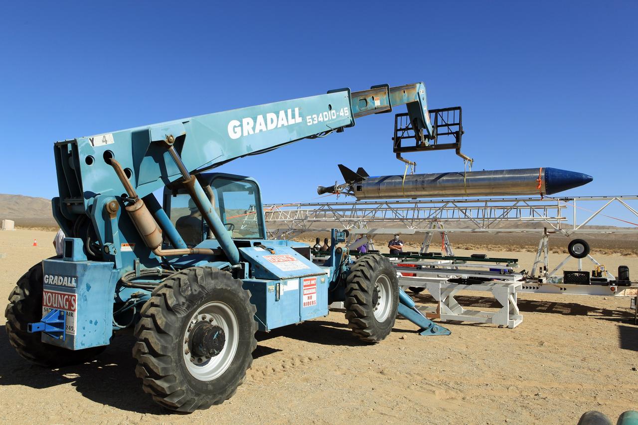 MOJAVE DESERT, Calif. – In the Mojave Desert in California, the Garvey Spacecraft Corporation's Prospector P-18D rocket is lifted into position for its scheduled launch on June 15 with the RUBICS-1 payload on a high-altitude, suborbital flight. The rocket will carry four satellites made from four-inch cube sections. Collectively known as CubeSats, the satellites will record shock, vibrations and heat inside the rocket. They will not be released during the test flight, but the results will be used to prove or strengthen their designs before they are carried into orbit in 2014 on a much larger rocket. A new, lightweight carrier is also being tested for use on future missions to deploy the small spacecraft. The flight also is being watched closely as a model for trying out new or off-the-shelf technologies quickly before putting them in the pipeline for use on NASA's largest launchers. Built by several different organizations, including a university, a NASA field center and a high school, the spacecraft are four-inch cubes designed to fly on their own eventually, but will remain firmly attached to the rocket during the upcoming mission. For more information, visit http://www.nasa.gov/mission_pages/smallsats/elana/cubesatlaunchpreview.html Photo credit: NASA/Dimitri Gerondidakis