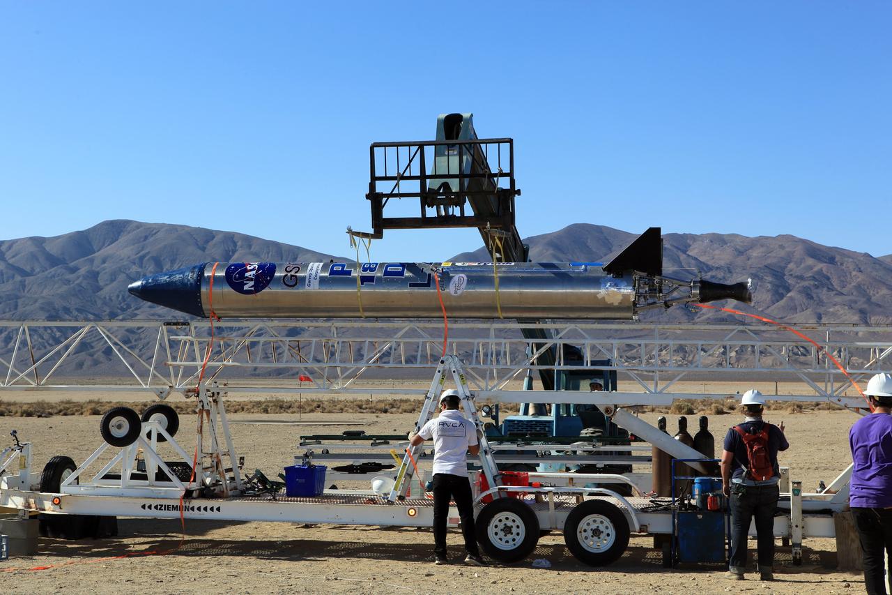 MOJAVE DESERT, Calif. – In the Mojave Desert in California, students and engineers assist as the Garvey Spacecraft Corporation's Prospector P-18D rocket is lifted into position for its scheduled launch on June 15 with the RUBICS-1 payload on a high-altitude, suborbital flight. The rocket will carry four satellites made from four-inch cube sections. Collectively known as CubeSats, the satellites will record shock, vibrations and heat inside the rocket. They will not be released during the test flight, but the results will be used to prove or strengthen their designs before they are carried into orbit in 2014 on a much larger rocket. A new, lightweight carrier is also being tested for use on future missions to deploy the small spacecraft. The flight also is being watched closely as a model for trying out new or off-the-shelf technologies quickly before putting them in the pipeline for use on NASA's largest launchers. Built by several different organizations, including a university, a NASA field center and a high school, the spacecraft are four-inch cubes designed to fly on their own eventually, but will remain firmly attached to the rocket during the upcoming mission. For more information, visit http://www.nasa.gov/mission_pages/smallsats/elana/cubesatlaunchpreview.html Photo credit: NASA/Dimitri Gerondidakis