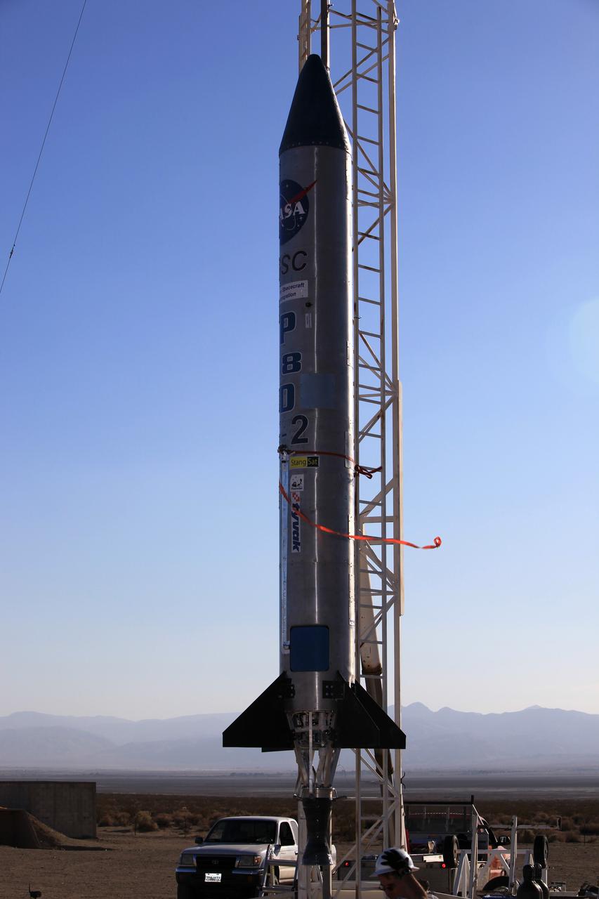 MOJAVE DESERT, Calif. – In the Mojave Desert in California, the Garvey Spacecraft Corporation's Prospector P-18D rocket is lifted into position for its scheduled launch on June 15 with the RUBICS-1 payload on a high-altitude, suborbital flight. The rocket will carry four satellites made from four-inch cube sections. Collectively known as CubeSats, the satellites will record shock, vibrations and heat inside the rocket. They will not be released during the test flight, but the results will be used to prove or strengthen their designs before they are carried into orbit in 2014 on a much larger rocket. A new, lightweight carrier is also being tested for use on future missions to deploy the small spacecraft. The flight also is being watched closely as a model for trying out new or off-the-shelf technologies quickly before putting them in the pipeline for use on NASA's largest launchers. Built by several different organizations, including a university, a NASA field center and a high school, the spacecraft are four-inch cubes designed to fly on their own eventually, but will remain firmly attached to the rocket during the upcoming mission. For more information, visit http://www.nasa.gov/mission_pages/smallsats/elana/cubesatlaunchpreview.html Photo credit: NASA/Dimitri Gerondidakis