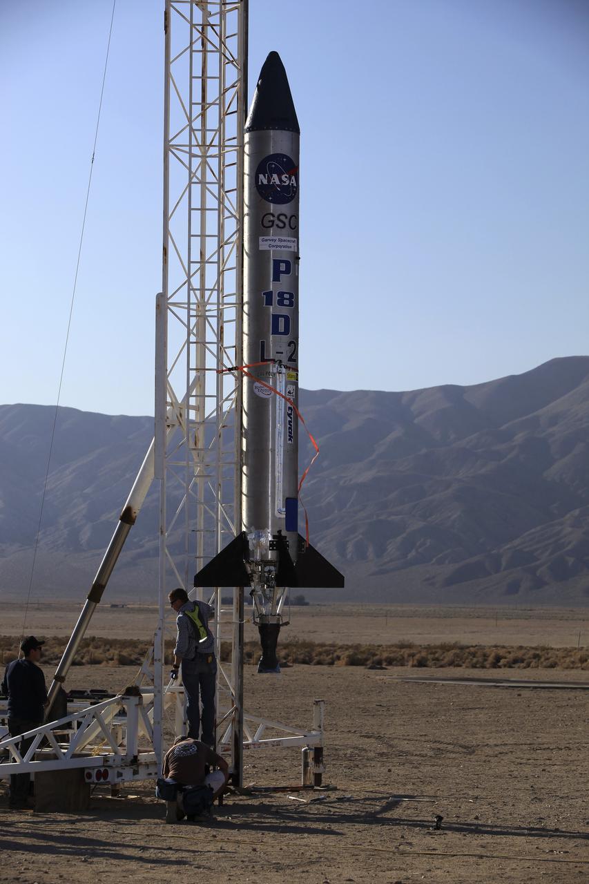 MOJAVE DESERT, Calif. – In the Mojave Desert in California, the Garvey Spacecraft Corporation's Prospector P-18D rocket is positioned for its scheduled launch on June 15 with the RUBICS-1 payload on a high-altitude, suborbital flight. The rocket will carry four satellites made from four-inch cube sections. Collectively known as CubeSats, the satellites will record shock, vibrations and heat inside the rocket. They will not be released during the test flight, but the results will be used to prove or strengthen their designs before they are carried into orbit in 2014 on a much larger rocket. A new, lightweight carrier is also being tested for use on future missions to deploy the small spacecraft. The flight also is being watched closely as a model for trying out new or off-the-shelf technologies quickly before putting them in the pipeline for use on NASA's largest launchers. Built by several different organizations, including a university, a NASA field center and a high school, the spacecraft are four-inch cubes designed to fly on their own eventually, but will remain firmly attached to the rocket during the upcoming mission. For more information, visit http://www.nasa.gov/mission_pages/smallsats/elana/cubesatlaunchpreview.html Photo credit: NASA/Dimitri Gerondidakis