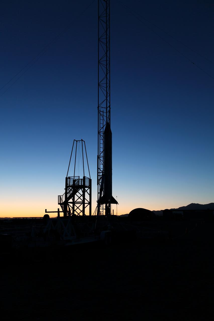 MOJAVE DESERT, Calif. – As the sun rises in the Mojave Desert in California, the Garvey Spacecraft Corporation's Prospector P-18D rocket is positioned for launch with the RUBICS-1 payload on a high-altitude, suborbital flight. The rocket will carry four satellites made from four-inch cube sections. Collectively known as CubeSats, the satellites will record shock, vibrations and heat inside the rocket. They will not be released during the test flight, but the results will be used to prove or strengthen their designs before they are carried into orbit in 2014 on a much larger rocket. A new, lightweight carrier is also being tested for use on future missions to deploy the small spacecraft. The flight also is being watched closely as a model for trying out new or off-the-shelf technologies quickly before putting them in the pipeline for use on NASA's largest launchers. Built by several different organizations, including a university, a NASA field center and a high school, the spacecraft are four-inch cubes designed to fly on their own eventually, but will remain firmly attached to the rocket during the upcoming mission. For more information, visit http://www.nasa.gov/mission_pages/smallsats/elana/cubesatlaunchpreview.html Photo credit: NASA/Dimitri Gerondidakis