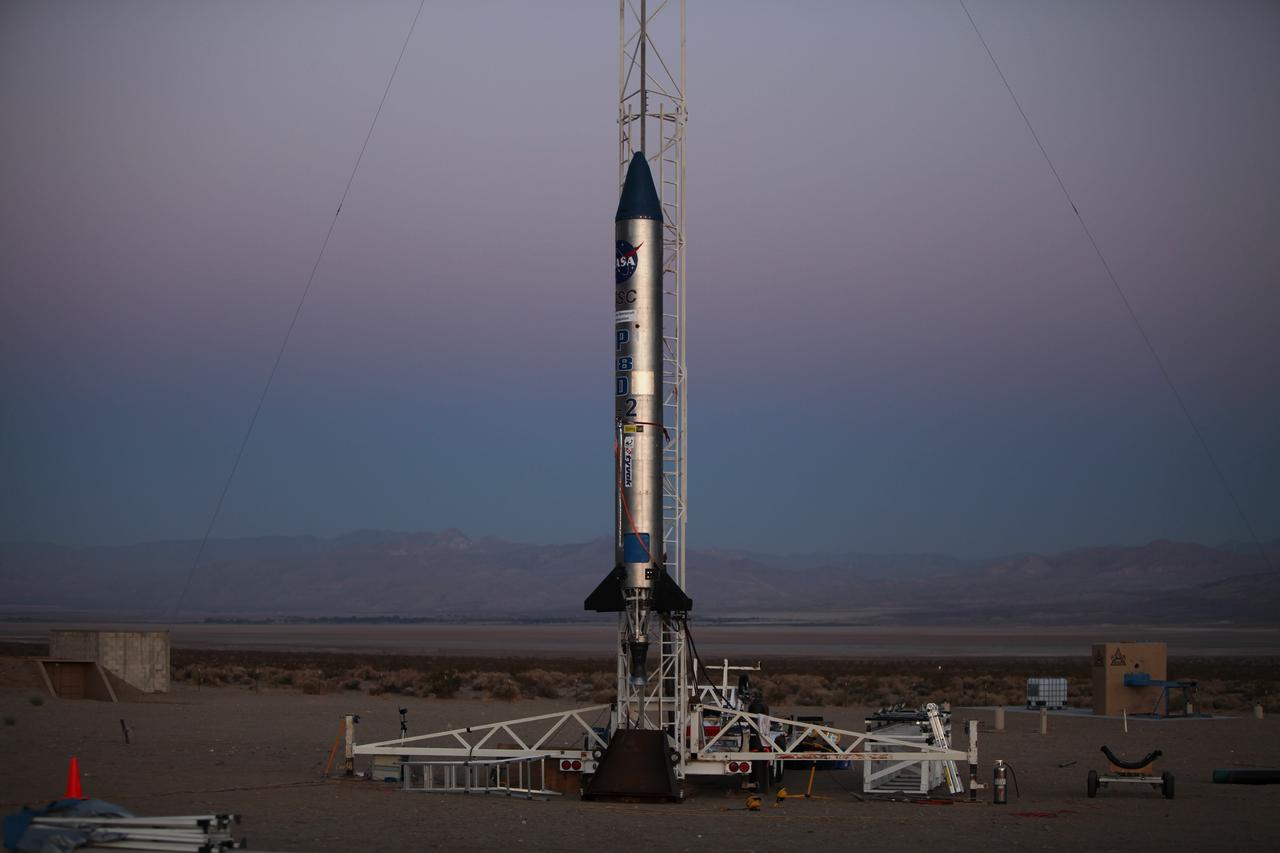 MOJAVE DESERT, Calif. – As the sun rises in the Mojave Desert in California, the Garvey Spacecraft Corporation's Prospector P-18D rocket is positioned for launch with the RUBICS-1 payload on a high-altitude, suborbital flight. The rocket will carry four satellites made from four-inch cube sections. Collectively known as CubeSats, the satellites will record shock, vibrations and heat inside the rocket. They will not be released during the test flight, but the results will be used to prove or strengthen their designs before they are carried into orbit in 2014 on a much larger rocket. A new, lightweight carrier is also being tested for use on future missions to deploy the small spacecraft. The flight also is being watched closely as a model for trying out new or off-the-shelf technologies quickly before putting them in the pipeline for use on NASA's largest launchers. Built by several different organizations, including a university, a NASA field center and a high school, the spacecraft are four-inch cubes designed to fly on their own eventually, but will remain firmly attached to the rocket during the upcoming mission. For more information, visit http://www.nasa.gov/mission_pages/smallsats/elana/cubesatlaunchpreview.html Photo credit: NASA/Dimitri Gerondidakis