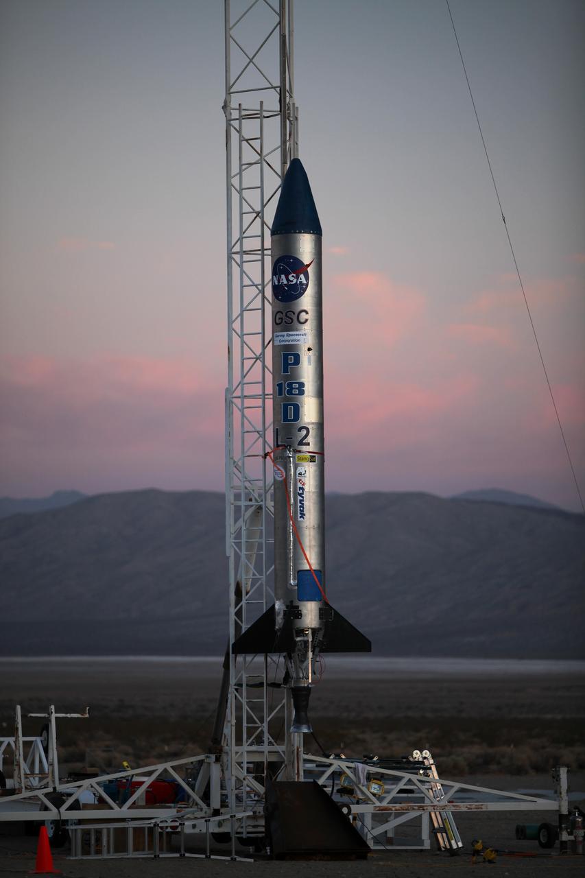 MOJAVE DESERT, Calif. – As the sun rises in the Mojave Desert in California, the Garvey Spacecraft Corporation's Prospector P-18D rocket is positioned for launch with the RUBICS-1 payload on a high-altitude, suborbital flight. The rocket will carry four satellites made from four-inch cube sections. Collectively known as CubeSats, the satellites will record shock, vibrations and heat inside the rocket. They will not be released during the test flight, but the results will be used to prove or strengthen their designs before they are carried into orbit in 2014 on a much larger rocket. A new, lightweight carrier is also being tested for use on future missions to deploy the small spacecraft. The flight also is being watched closely as a model for trying out new or off-the-shelf technologies quickly before putting them in the pipeline for use on NASA's largest launchers. Built by several different organizations, including a university, a NASA field center and a high school, the spacecraft are four-inch cubes designed to fly on their own eventually, but will remain firmly attached to the rocket during the upcoming mission. For more information, visit http://www.nasa.gov/mission_pages/smallsats/elana/cubesatlaunchpreview.html Photo credit: NASA/Dimitri Gerondidakis