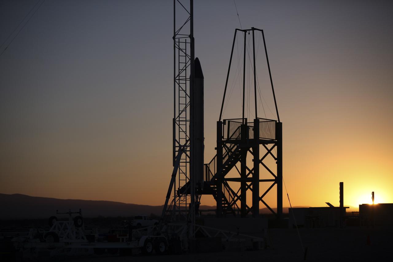 MOJAVE DESERT, Calif. – As the sun rises in the Mojave Desert in California, the Garvey Spacecraft Corporation's Prospector P-18D rocket is positioned for launch with the RUBICS-1 payload on a high-altitude, suborbital flight. The rocket will carry four satellites made from four-inch cube sections. Collectively known as CubeSats, the satellites will record shock, vibrations and heat inside the rocket. They will not be released during the test flight, but the results will be used to prove or strengthen their designs before they are carried into orbit in 2014 on a much larger rocket. A new, lightweight carrier is also being tested for use on future missions to deploy the small spacecraft. The flight also is being watched closely as a model for trying out new or off-the-shelf technologies quickly before putting them in the pipeline for use on NASA's largest launchers. Built by several different organizations, including a university, a NASA field center and a high school, the spacecraft are four-inch cubes designed to fly on their own eventually, but will remain firmly attached to the rocket during the upcoming mission. For more information, visit http://www.nasa.gov/mission_pages/smallsats/elana/cubesatlaunchpreview.html Photo credit: NASA/Dimitri Gerondidakis