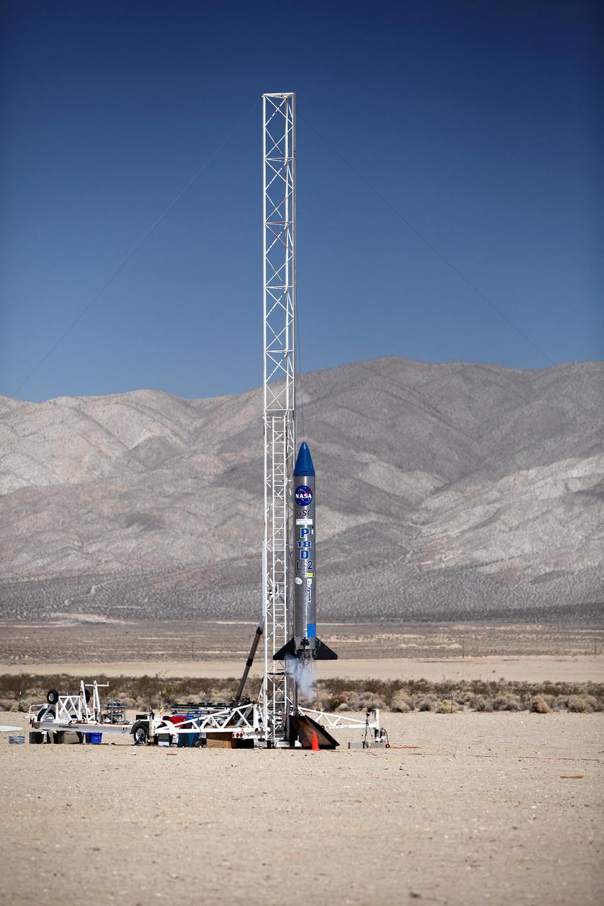 MOJAVE DESERT, Calif. – In the Mojave Desert in California, the ignition sequence begins on the Garvey Spacecraft Corporation's Prospector P-18D rocket. The vehicle is carrying the RUBICS-1 payload on a high-altitude, suborbital flight. The rocket carried four satellites made from four-inch cube sections.      The rocket reached a peak altitude of about 9,000 feet, however the parachute deployed prematurely and the vehicle continued on its trajectory, coasting and tumbling to a hard landing on its side. In spite of the rough ride, all four CubeSats were recovered. PhoneSat and RUBICS received data in flight, but sustained structural damage. CP-9 and StangSat fared better, and their teams are working to recover as much information as possible. Collectively known as CubeSats, the satellites were designed to record shock, vibrations and heat inside the rocket. The results will be used to prove or strengthen their designs before they are carried into orbit in 2014 on a much larger rocket. Built by several different organizations, including a university, a NASA field center and a high school, the spacecraft are four-inch cubes designed to fly on their own eventually, but will remain firmly attached to the rocket during the upcoming mission. For more information, visit http://www.nasa.gov/mission_pages/smallsats/elana/cubesatlaunchpreview.html Photo credit: NASA/Dimitri Gerondidakis