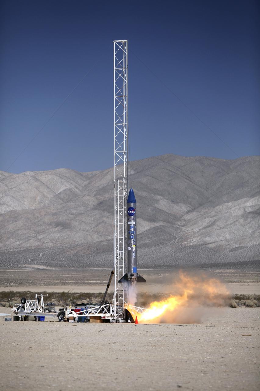 MOJAVE DESERT, Calif. – In the Mojave Desert in California, the Garvey Spacecraft Corporation's Prospector P-18D rocket lifts off at 10:52 a.m. PDT carrying the RUBICS-1 payload on a high-altitude, suborbital flight. The rocket carried four satellites made from four-inch cube sections.      The rocket reached a peak altitude of about 9,000 feet, however the parachute deployed prematurely and the vehicle continued on its trajectory, coasting and tumbling to a hard landing on its side. In spite of the rough ride, all four CubeSats were recovered. PhoneSat and RUBICS received data in flight, but sustained structural damage. CP-9 and StangSat fared better, and their teams are working to recover as much information as possible. Collectively known as CubeSats, the satellites were designed to record shock, vibrations and heat inside the rocket. The results will be used to prove or strengthen their designs before they are carried into orbit in 2014 on a much larger rocket. Built by several different organizations, including a university, a NASA field center and a high school, the spacecraft are four-inch cubes designed to fly on their own eventually, but will remain firmly attached to the rocket during the upcoming mission. For more information, visit http://www.nasa.gov/mission_pages/smallsats/elana/cubesatlaunchpreview.html Photo credit: NASA/Dimitri Gerondidakis