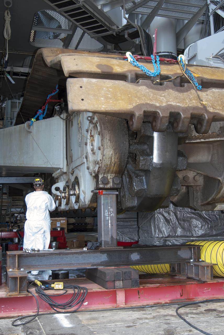 CAPE CANAVERAL, Fla. -- Technicians in the Vehicle Assembly Building at NASA’s Kennedy Space Center in Florida, are removing cover plates in preparation for replacing the roller bearing assemblies on crawler-transporter 2, or CT-2. The modifications are designed to ensure CT-2's ability to transport launch vehicles currently in development, such as the agency's Space Launch System which will send the Orion spacecraft carrying humans to new destinations in the solar system. The Ground Systems Development and Operations Program office at Kennedy is overseeing the upgrades to CT-2 so that it can carry NASA’s Space Launch System heavy-lift rocket and new Orion spacecraft to the launch pad. For more than 45 years the crawler-transporters were used to transport the mobile launcher platform and the Apollo-Saturn V rockets and, later, space shuttles to Launch Pads 39A and B. For more information, visit: http://www.nasa.gov/exploration/systems/ground/crawler-transporter_bearings.html Photo credit: NASA/Tim Jacobs