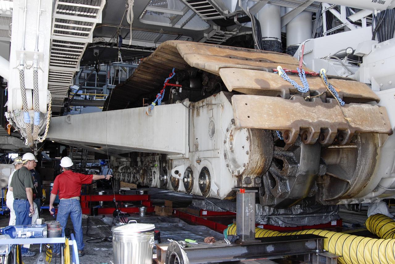 CAPE CANAVERAL, Fla. -- Technicians in the Vehicle Assembly Building at NASA’s Kennedy Space Center in Florida, are removing cover plates in preparation for replacing the roller bearing assemblies on crawler-transporter 2, or CT-2. The modifications are designed to ensure CT-2's ability to transport launch vehicles currently in development, such as the agency's Space Launch System which will send the Orion spacecraft carrying humans to new destinations in the solar system. The Ground Systems Development and Operations Program office at Kennedy is overseeing the upgrades to CT-2 so that it can carry NASA’s Space Launch System heavy-lift rocket and new Orion spacecraft to the launch pad. For more than 45 years the crawler-transporters were used to transport the mobile launcher platform and the Apollo-Saturn V rockets and, later, space shuttles to Launch Pads 39A and B. For more information, visit: http://www.nasa.gov/exploration/systems/ground/crawler-transporter_bearings.html Photo credit: NASA/Tim Jacobs