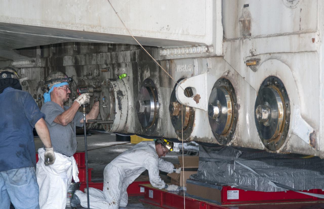 CAPE CANAVERAL, Fla. -- Technicians in the Vehicle Assembly Building at NASA’s Kennedy Space Center in Florida, are removing cover plates in preparation for replacing the roller bearing assemblies on crawler-transporter 2, or CT-2. The modifications are designed to ensure CT-2's ability to transport launch vehicles currently in development, such as the agency's Space Launch System which will send the Orion spacecraft carrying humans to new destinations in the solar system. The Ground Systems Development and Operations Program office at Kennedy is overseeing the upgrades to CT-2 so that it can carry NASA’s Space Launch System heavy-lift rocket and new Orion spacecraft to the launch pad. For more than 45 years the crawler-transporters were used to transport the mobile launcher platform and the Apollo-Saturn V rockets and, later, space shuttles to Launch Pads 39A and B. For more information, visit: http://www.nasa.gov/exploration/systems/ground/crawler-transporter_bearings.html Photo credit: NASA/Tim Jacobs