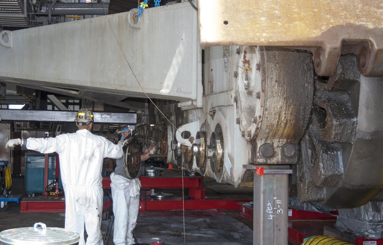 CAPE CANAVERAL, Fla. -- Technicians in the Vehicle Assembly Building at NASA’s Kennedy Space Center in Florida, are removing cover plates in preparation for replacing the roller bearing assemblies on crawler-transporter 2, or CT-2. The modifications are designed to ensure CT-2's ability to transport launch vehicles currently in development, such as the agency's Space Launch System which will send the Orion spacecraft carrying humans to new destinations in the solar system. The Ground Systems Development and Operations Program office at Kennedy is overseeing the upgrades to CT-2 so that it can carry NASA’s Space Launch System heavy-lift rocket and new Orion spacecraft to the launch pad. For more than 45 years the crawler-transporters were used to transport the mobile launcher platform and the Apollo-Saturn V rockets and, later, space shuttles to Launch Pads 39A and B. For more information, visit: http://www.nasa.gov/exploration/systems/ground/crawler-transporter_bearings.html Photo credit: NASA/Tim Jacobs