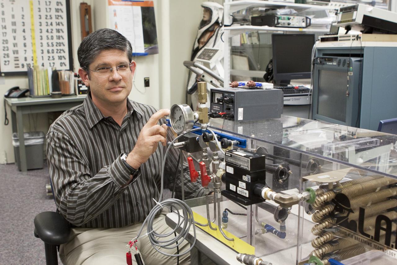 CAPE CANAVERAL, Fla. - NASA Kennedy Space Center Lead Engineer David Bush works on a prototype of a Cryogenic Refuge Alternative Supply System, or CryoRASS, in the Operations and Checkout Building. CryoRASS and a small liquid-air filled backpack called CryoBA, short for Cryogenic Breathing Apparatus, are being developed by a NASA Kennedy Space Center engineering team in collaboration with The National Institute for Occupational Safety and Health to provide miners with twice the amount of breathable and cooler air than traditional compressed systems. The technology also could be used for commercial applications, such as fire and military rescue operations, as well as NASA's future human spaceflight missions. Photo credit: NASA/Jim Gossmann