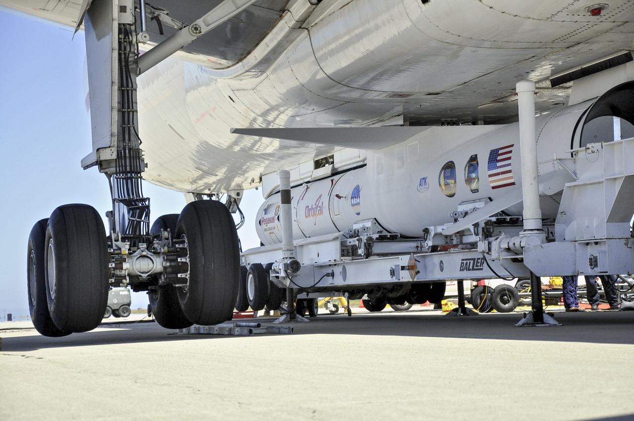 VANDENBERG AIR FORCE BASE, Calif. – Technicians and engineers at Vandenberg Air Force Base in California mate the Pegasus XL rocket with the Interface Region Imaging Spectrograph, or IRIS, solar observatory to the Orbital Sciences L-1011 carrier aircraft.      Scheduled for launch from Vandenberg on June 26, 2013, IRIS will open a new window of discovery by tracing the flow of energy and plasma through the chromospheres and transition region into the sun’s corona using spectrometry and imaging. The IRIS mission will observe how solar material moves, gathers energy and heats up as it travels through a largely unexplored region of the solar atmosphere. The interface region, located between the sun's visible surface and upper atmosphere, is where most of the sun's ultraviolet emission is generated. These emissions impact the near-Earth space environment and Earth's climate.   For more information, visit http://www.nasa.gov/iris Photo credit: NASA/Randy Beaudoin