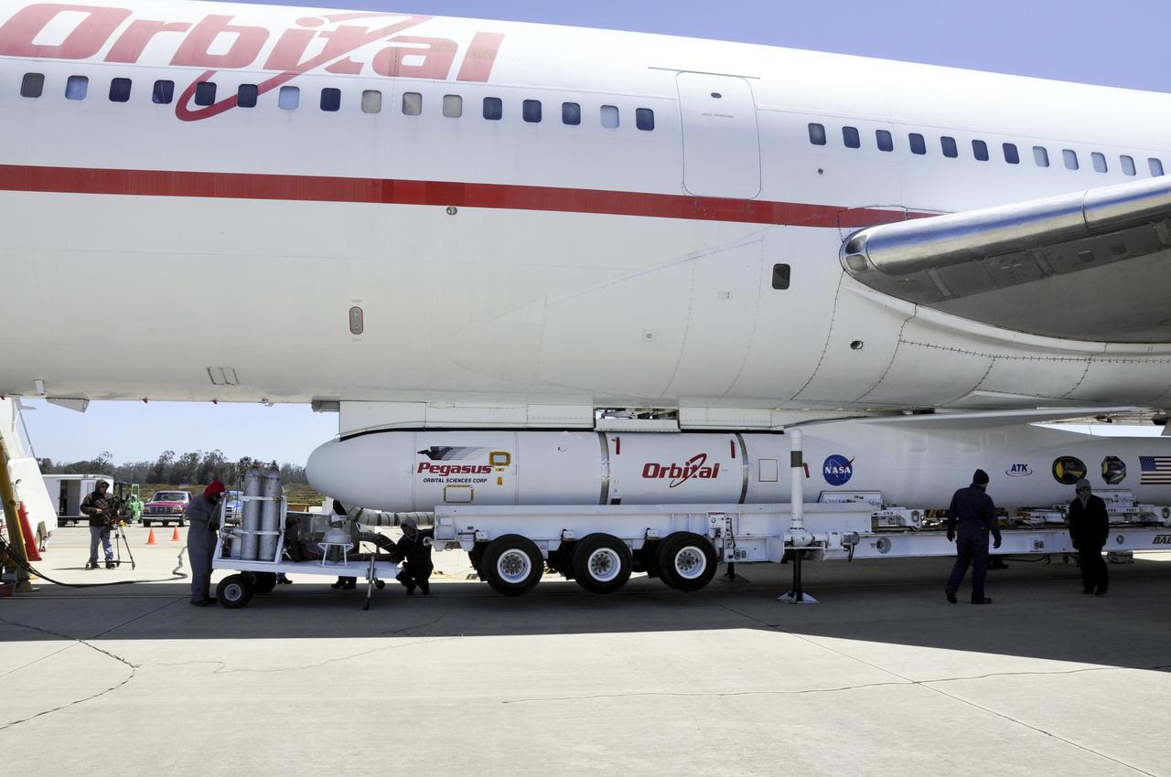 VANDENBERG AIR FORCE BASE, Calif. – Technicians and engineers at Vandenberg Air Force Base in California mate the Pegasus XL rocket with the Interface Region Imaging Spectrograph, or IRIS, solar observatory to the Orbital Sciences L-1011 carrier aircraft.      Scheduled for launch from Vandenberg on June 26, 2013, IRIS will open a new window of discovery by tracing the flow of energy and plasma through the chromospheres and transition region into the sun’s corona using spectrometry and imaging. The IRIS mission will observe how solar material moves, gathers energy and heats up as it travels through a largely unexplored region of the solar atmosphere. The interface region, located between the sun's visible surface and upper atmosphere, is where most of the sun's ultraviolet emission is generated. These emissions impact the near-Earth space environment and Earth's climate.   For more information, visit http://www.nasa.gov/iris Photo credit: NASA/Randy Beaudoin