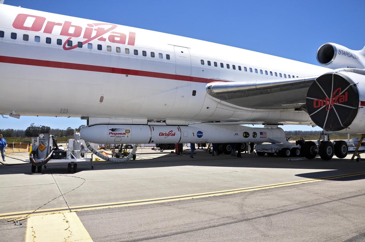 VANDENBERG AIR FORCE BASE, Calif. – Technicians and engineers at Vandenberg Air Force Base in California mate the Pegasus XL rocket with the Interface Region Imaging Spectrograph, or IRIS, solar observatory to the Orbital Sciences L-1011 carrier aircraft.      Scheduled for launch from Vandenberg on June 26, 2013, IRIS will open a new window of discovery by tracing the flow of energy and plasma through the chromospheres and transition region into the sun’s corona using spectrometry and imaging. The IRIS mission will observe how solar material moves, gathers energy and heats up as it travels through a largely unexplored region of the solar atmosphere. The interface region, located between the sun's visible surface and upper atmosphere, is where most of the sun's ultraviolet emission is generated. These emissions impact the near-Earth space environment and Earth's climate.   For more information, visit http://www.nasa.gov/iris Photo credit: NASA/Randy Beaudoin