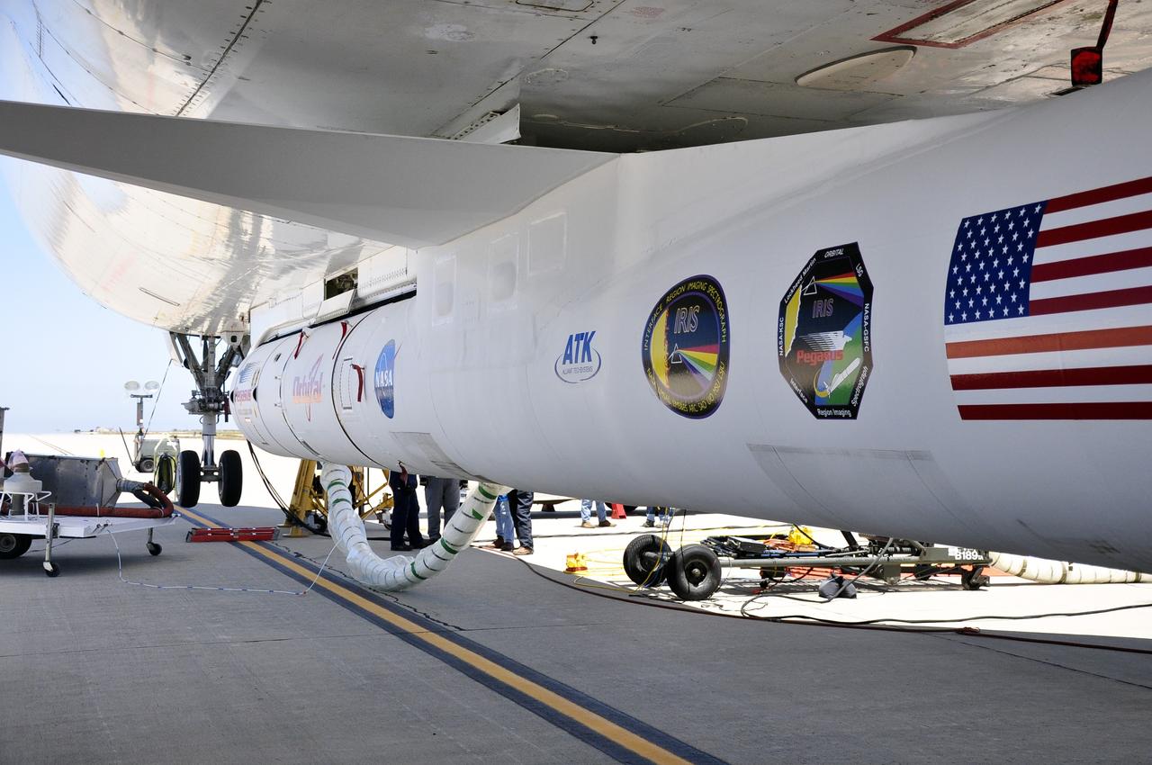 VANDENBERG AIR FORCE BASE, Calif. – Technicians and engineers at Vandenberg Air Force Base in California mate the Pegasus XL rocket with the Interface Region Imaging Spectrograph, or IRIS, solar observatory to the Orbital Sciences L-1011 carrier aircraft.      Scheduled for launch from Vandenberg on June 26, 2013, IRIS will open a new window of discovery by tracing the flow of energy and plasma through the chromospheres and transition region into the sun’s corona using spectrometry and imaging. The IRIS mission will observe how solar material moves, gathers energy and heats up as it travels through a largely unexplored region of the solar atmosphere. The interface region, located between the sun's visible surface and upper atmosphere, is where most of the sun's ultraviolet emission is generated. These emissions impact the near-Earth space environment and Earth's climate.   For more information, visit http://www.nasa.gov/iris Photo credit: NASA/Randy Beaudoin