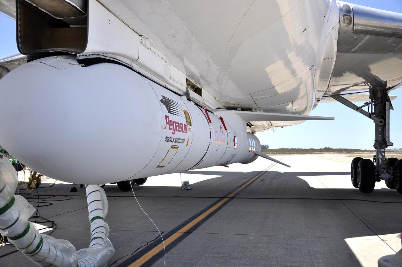 VANDENBERG AIR FORCE BASE, Calif. – Technicians and engineers at Vandenberg Air Force Base in California mate the Pegasus XL rocket with the Interface Region Imaging Spectrograph, or IRIS, solar observatory to the Orbital Sciences L-1011 carrier aircraft.      Scheduled for launch from Vandenberg on June 26, 2013, IRIS will open a new window of discovery by tracing the flow of energy and plasma through the chromospheres and transition region into the sun’s corona using spectrometry and imaging. The IRIS mission will observe how solar material moves, gathers energy and heats up as it travels through a largely unexplored region of the solar atmosphere. The interface region, located between the sun's visible surface and upper atmosphere, is where most of the sun's ultraviolet emission is generated. These emissions impact the near-Earth space environment and Earth's climate.   For more information, visit http://www.nasa.gov/iris Photo credit: NASA/Randy Beaudoin