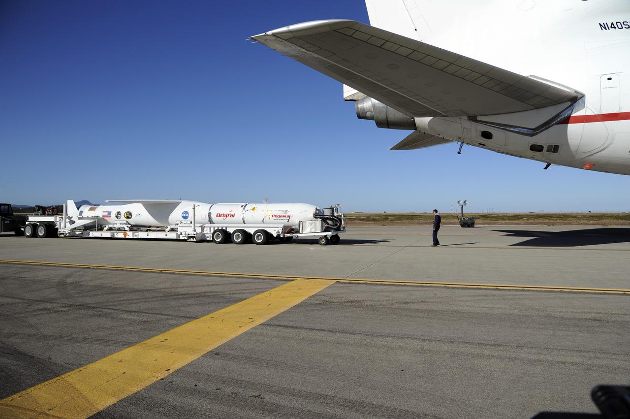 VANDENBERG AIR FORCE BASE, Calif. – At Vandenberg Air Force Base in California, the Pegasus XL rocket with the attached Interface Region Imaging Spectrograph IRIS solar observatory rolled out of the hangar on its transporter to the runway at Vandenberg. There, the rocket and spacecraft were mated with the Orbital Sciences L-1011 carrier aircraft.      Scheduled for launch from Vandenberg on June 26, 2013, IRIS will open a new window of discovery by tracing the flow of energy and plasma through the chromospheres and transition region into the sun’s corona using spectrometry and imaging. The IRIS mission will observe how solar material moves, gathers energy and heats up as it travels through a largely unexplored region of the solar atmosphere. The interface region, located between the sun's visible surface and upper atmosphere, is where most of the sun's ultraviolet emission is generated. These emissions impact the near-Earth space environment and Earth's climate.   For more information, visit http://www.nasa.gov/iris Photo credit: NASA/Randy Beaudoin