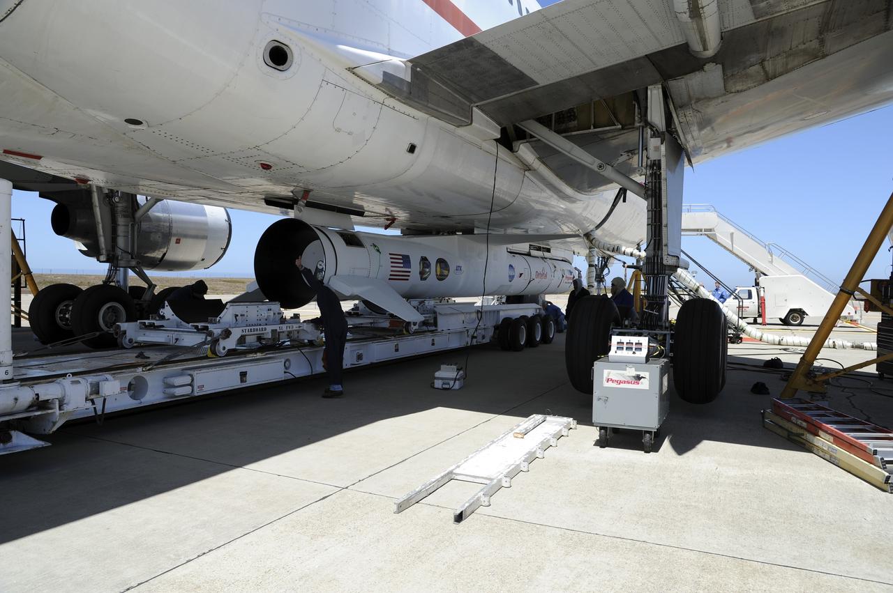 VANDENBERG AIR FORCE BASE, Calif. – At Vandenberg Air Force Base in California, the Pegasus XL rocket with the attached Interface Region Imaging Spectrograph IRIS solar observatory rolled out of the hangar on its transporter to the runway at Vandenberg. There, the rocket and spacecraft were mated with the Orbital Sciences L-1011 carrier aircraft.      Scheduled for launch from Vandenberg on June 26, 2013, IRIS will open a new window of discovery by tracing the flow of energy and plasma through the chromospheres and transition region into the sun’s corona using spectrometry and imaging. The IRIS mission will observe how solar material moves, gathers energy and heats up as it travels through a largely unexplored region of the solar atmosphere. The interface region, located between the sun's visible surface and upper atmosphere, is where most of the sun's ultraviolet emission is generated. These emissions impact the near-Earth space environment and Earth's climate.   For more information, visit http://www.nasa.gov/iris Photo credit: NASA/Randy Beaudoin