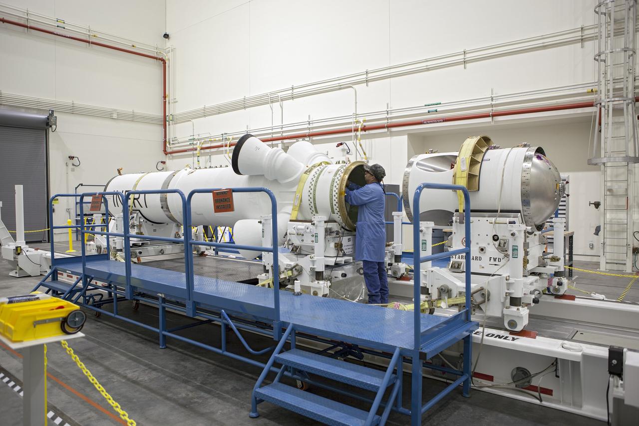CAPE CANAVERAL, Fla. -- Inside the Launch Abort System Facility at NASA’s Kennedy Space Center in Florida, a technician prepares the launch abort motor for connection to the attitude control motor. Both are segments of Orion’s Launch Abort System, which is designed to safely pull the Orion crew module away from the launch vehicle in the event of an emergency on the launch pad or during the initial ascent of NASA’s Space Launch System, or SLS, rocket. Orion is the exploration spacecraft designed to carry crews to space beyond low Earth orbit. It will provide emergency abort capability, sustain the crew during the space travel and provide safe re-entry from deep space return velocities. Orion’s first unpiloted test flight is scheduled to launch in 2014 atop a Delta IV rocket. A second uncrewed flight test is scheduled for 2017 on the SLS rocket. For more information, visit http://www.nasa.gov/orion. Photo credit: NASA/Dimitri Gerondidakis
