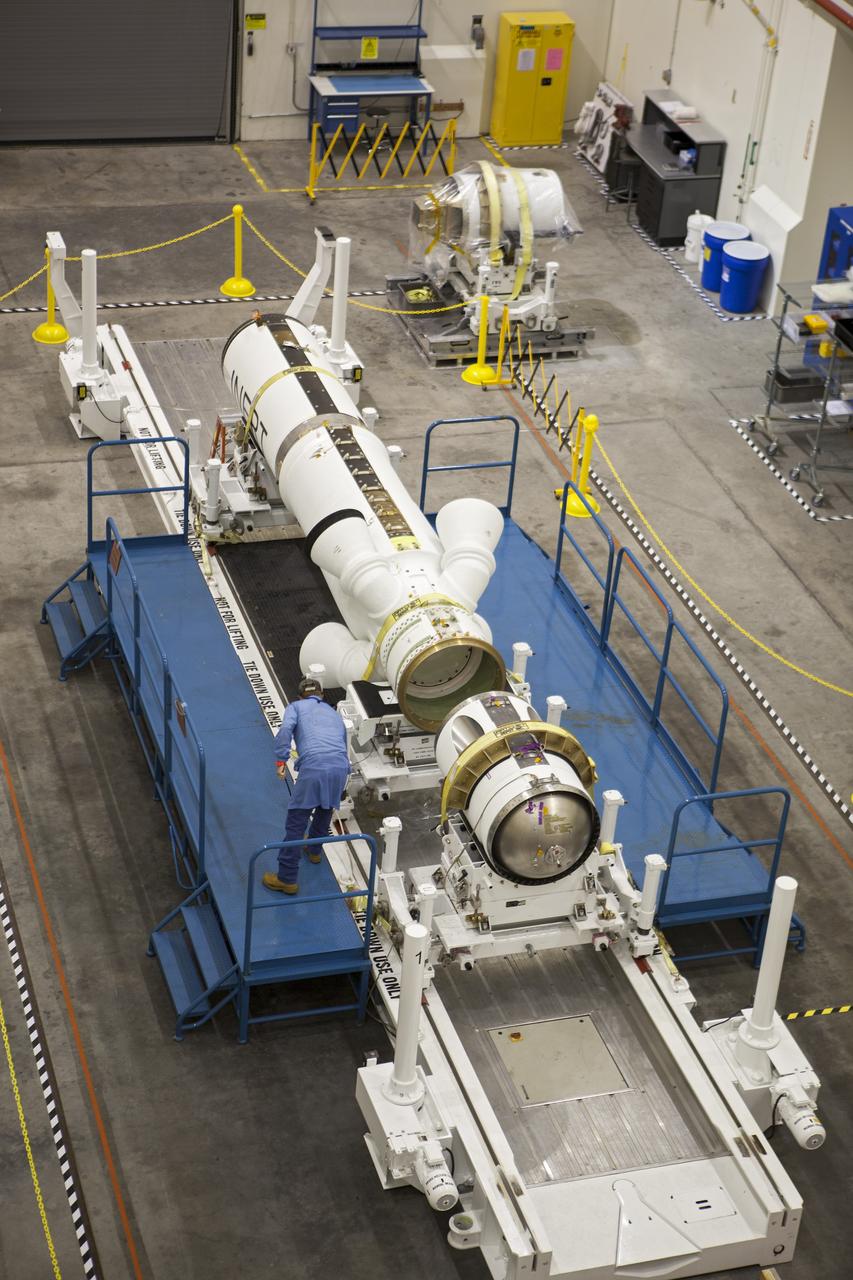 CAPE CANAVERAL, Fla. -- Inside the Launch Abort System Facility at NASA’s Kennedy Space Center in Florida, a technician prepares the launch abort motor for connection to the attitude control motor. Both are segments of Orion’s Launch Abort System, which is designed to safely pull the Orion crew module away from the launch vehicle in the event of an emergency on the launch pad or during the initial ascent of NASA’s Space Launch System, or SLS, rocket. Orion is the exploration spacecraft designed to carry crews to space beyond low Earth orbit. It will provide emergency abort capability, sustain the crew during the space travel and provide safe re-entry from deep space return velocities. Orion’s first unpiloted test flight is scheduled to launch in 2014 atop a Delta IV rocket. A second uncrewed flight test is scheduled for 2017 on the SLS rocket. For more information, visit http://www.nasa.gov/orion. Photo credit: NASA/Dimitri Gerondidakis