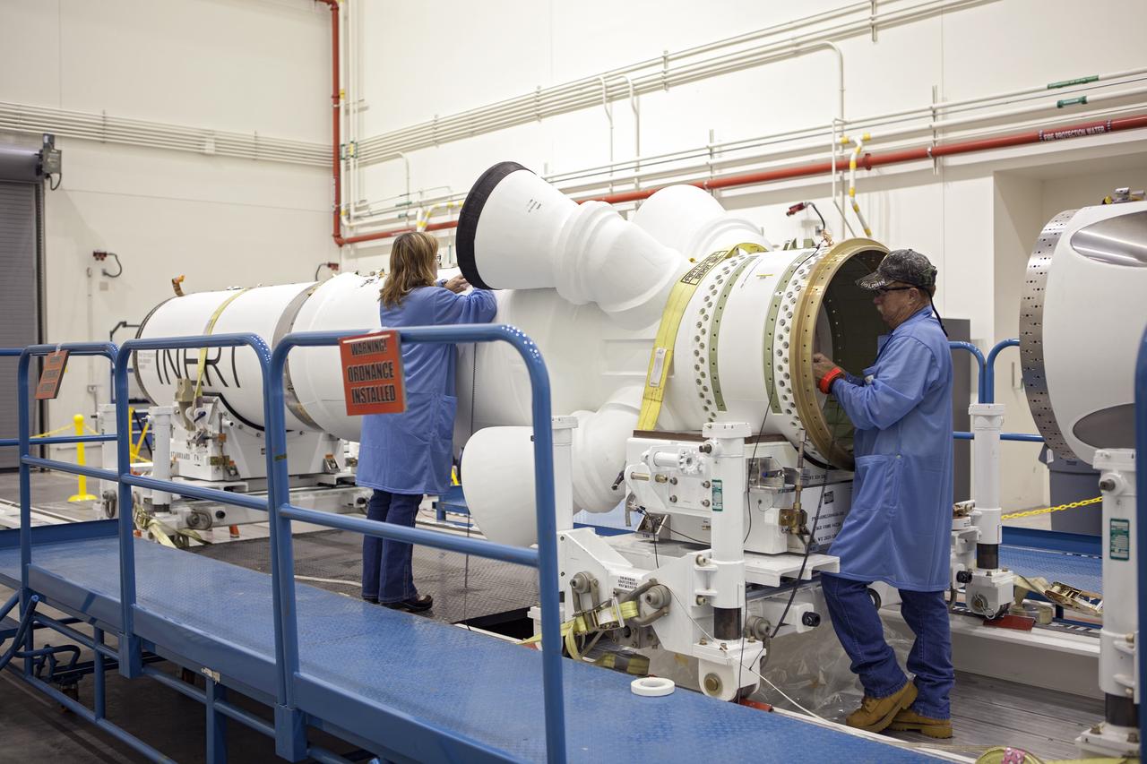 CAPE CANAVERAL, Fla. -- Inside the Launch Abort System Facility at NASA’s Kennedy Space Center in Florida, technicians prepare the launch abort motor for connection to the attitude control motor. Both are segments of Orion’s Launch Abort System, which is designed to safely pull the Orion crew module away from the launch vehicle in the event of an emergency on the launch pad or during the initial ascent of NASA’s Space Launch System, or SLS, rocket. Orion is the exploration spacecraft designed to carry crews to space beyond low Earth orbit. It will provide emergency abort capability, sustain the crew during the space travel and provide safe re-entry from deep space return velocities. Orion’s first unpiloted test flight is scheduled to launch in 2014 atop a Delta IV rocket. A second uncrewed flight test is scheduled for 2017 on the SLS rocket. For more information, visit http://www.nasa.gov/orion. Photo credit: NASA/Dimitri Gerondidakis