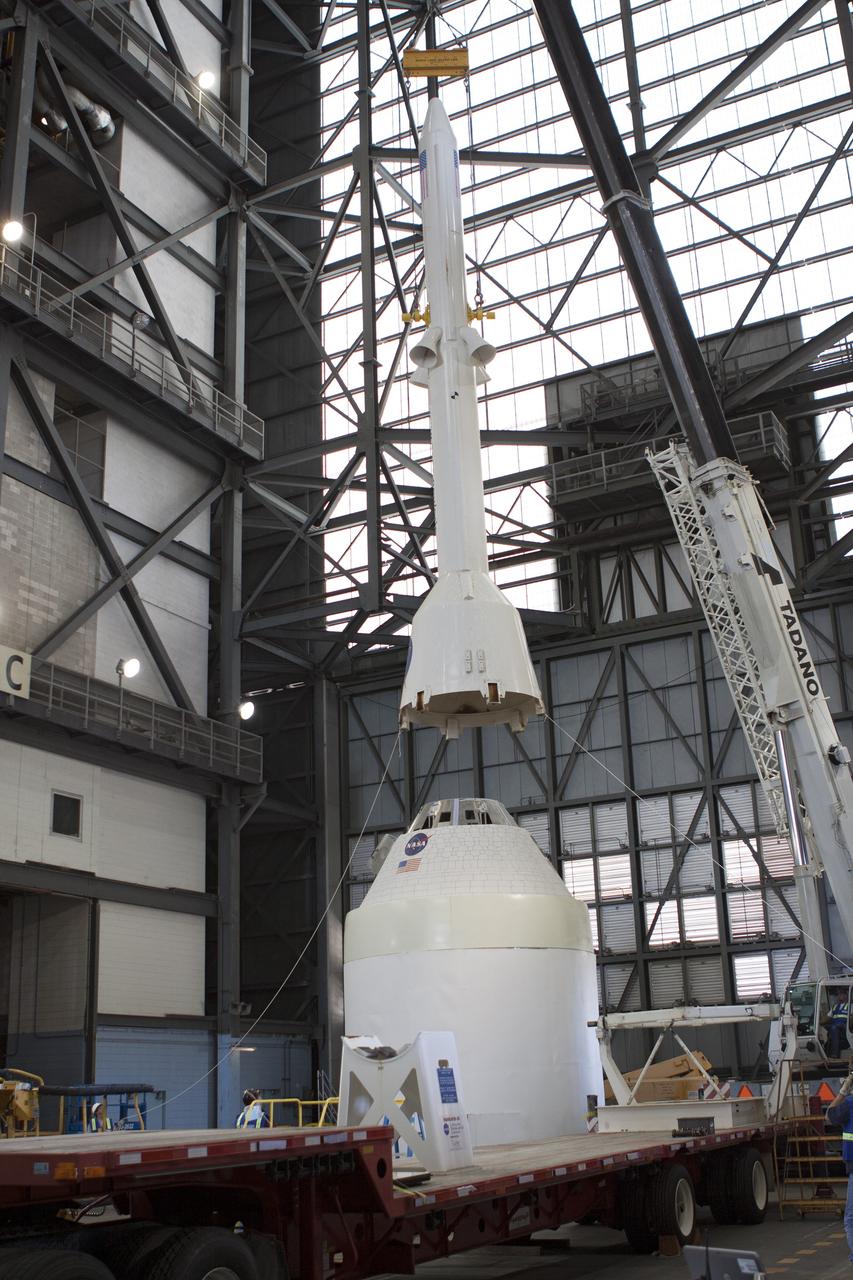 CAPE CANAVERAL, Fla. -- In the transfer aisle of the Vehicle Assembly Building at NASA’s Kennedy Space Center in Florida, crane operators and technicians practice de-stacking operations on a full-size mock-up of the Orion spacecraft and launch abort system in order to keep processing procedures and skills current. Orion is the exploration spacecraft designed to carry crews to space beyond low Earth orbit. It will provide emergency abort capability, sustain the crew during the space travel and provide safe re-entry from deep space return velocities. Orion’s first unpiloted test flight is scheduled to launch in 2014 atop a Delta IV rocket. A second uncrewed flight test is scheduled for 2017 on NASA’s Space Launch System rocket. For more information, visit http://www.nasa.gov/orion. Photo credit: NASA/Jim Grossmann