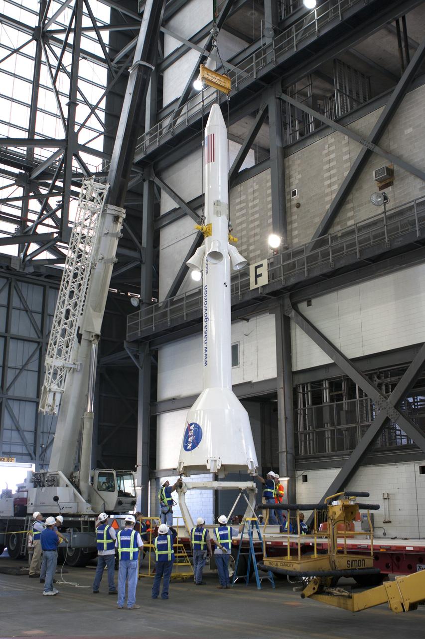 CAPE CANAVERAL, Fla. -- In the transfer aisle of the Vehicle Assembly Building at NASA’s Kennedy Space Center in Florida, crane operators and technicians practice de-stacking operations on a full-size mock-up of the Orion spacecraft and launch abort system in order to keep processing procedures and skills current. Orion is the exploration spacecraft designed to carry crews to space beyond low Earth orbit. It will provide emergency abort capability, sustain the crew during the space travel and provide safe re-entry from deep space return velocities. Orion’s first unpiloted test flight is scheduled to launch in 2014 atop a Delta IV rocket. A second uncrewed flight test is scheduled for 2017 on NASA’s Space Launch System rocket. For more information, visit http://www.nasa.gov/orion. Photo credit: NASA/Jim Grossmann
