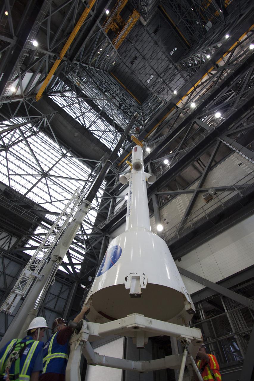 CAPE CANAVERAL, Fla. -- In the transfer aisle of the Vehicle Assembly Building at NASA’s Kennedy Space Center in Florida, crane operators and technicians practice de-stacking operations on a full-size mock-up of the Orion spacecraft and launch abort system in order to keep processing procedures and skills current. Orion is the exploration spacecraft designed to carry crews to space beyond low Earth orbit. It will provide emergency abort capability, sustain the crew during the space travel and provide safe re-entry from deep space return velocities. Orion’s first unpiloted test flight is scheduled to launch in 2014 atop a Delta IV rocket. A second uncrewed flight test is scheduled for 2017 on NASA’s Space Launch System rocket. For more information, visit http://www.nasa.gov/orion. Photo credit: NASA/Jim Grossmann