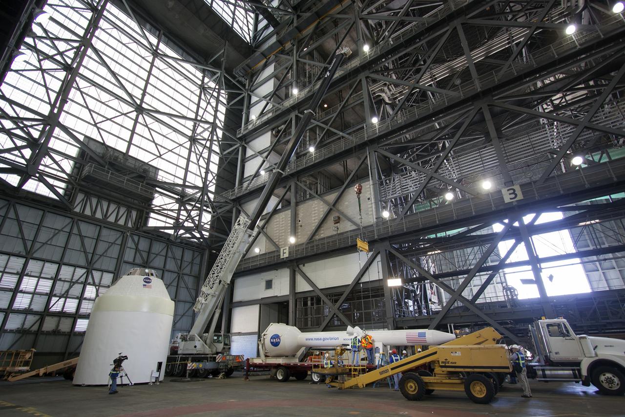 CAPE CANAVERAL, Fla. -- In the transfer aisle of the Vehicle Assembly Building at NASA’s Kennedy Space Center in Florida, a mock-up of the Orion launch abort system has been lowered onto a transporter. Crane operators and technicians practice de-stacking operations on a full-size mock-up of the Orion spacecraft and launch abort system in order to keep processing procedures and skills current. Orion is the exploration spacecraft designed to carry crews to space beyond low Earth orbit. It will provide emergency abort capability, sustain the crew during the space travel and provide safe re-entry from deep space return velocities. Orion’s first unpiloted test flight is scheduled to launch in 2014 atop a Delta IV rocket. A second uncrewed flight test is scheduled for 2017 on NASA’s Space Launch System rocket. For more information, visit http://www.nasa.gov/orion. Photo credit: NASA/Jim Grossmann