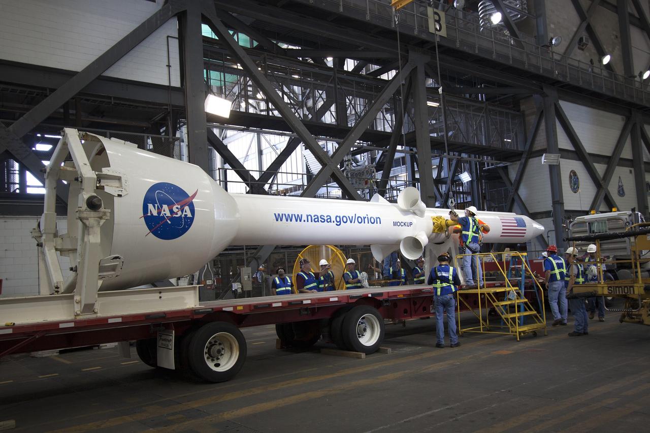 CAPE CANAVERAL, Fla. -- In the transfer aisle of the Vehicle Assembly Building at NASA’s Kennedy Space Center in Florida, a mock-up of the Orion launch abort system has been lowered onto a transporter. Crane operators and technicians practice de-stacking operations on a full-size mock-up of the Orion spacecraft and launch abort system in order to keep processing procedures and skills current. Orion is the exploration spacecraft designed to carry crews to space beyond low Earth orbit. It will provide emergency abort capability, sustain the crew during the space travel and provide safe re-entry from deep space return velocities. Orion’s first unpiloted test flight is scheduled to launch in 2014 atop a Delta IV rocket. A second uncrewed flight test is scheduled for 2017 on NASA’s Space Launch System rocket. For more information, visit http://www.nasa.gov/orion. Photo credit: NASA/Jim Grossmann