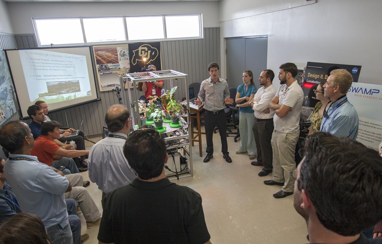 CAPE CANAVERAL, Fla. -- At the Kennedy Space Center in Florida, students from University of Colorado describe a robotic capability for growing a variety of plants, both for consumption as well as the benefit of oxygen-carbon dioxide cycling. Considerations range from monitoring and nutrient supply to selection of plants and autonomy. The activity is part of the eXploration Habitat, or X-Hab, Academic Innovation Challenge.      X-Hab Academic Innovation Challenge is a university-level activity designed to engage and retain students in Science, Technology, Engineering and Math, or STEM, disciplines. NASA will directly benefit from the effort by sponsoring the development of innovative habitat concepts from universities which may result in innovative ideas and solutions that could be applied to exploration habitats. For more: http://www.nasa.gov/exploration/technology/deep_space_habitat/xhab/ Photo credit: NASA/Jim Grossmann