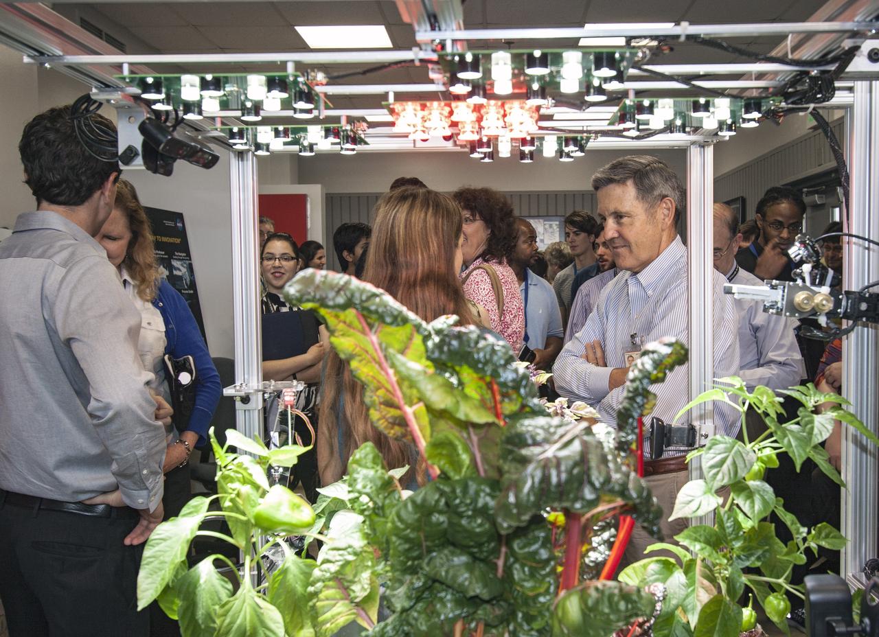 CAPE CANAVERAL, Fla. -- Kennedy Space Center Director Bob Cabana listens as a student from University of Colorado describes a robotic capability for growing a variety of plants, both for consumption as well as the benefit of oxygen-carbon dioxide cycling. Considerations range from monitoring and nutrient supply to selection of plants and autonomy. The activity is part of the eXploration Habitat, or X-Hab, Academic Innovation Challenge.      X-Hab Academic Innovation Challenge is a university-level activity designed to engage and retain students in Science, Technology, Engineering and Math, or STEM, disciplines. NASA will directly benefit from the effort by sponsoring the development of innovative habitat concepts from universities which may result in innovative ideas and solutions that could be applied to exploration habitats. For more: http://www.nasa.gov/exploration/technology/deep_space_habitat/xhab/ Photo credit: NASA/Jim Grossmann