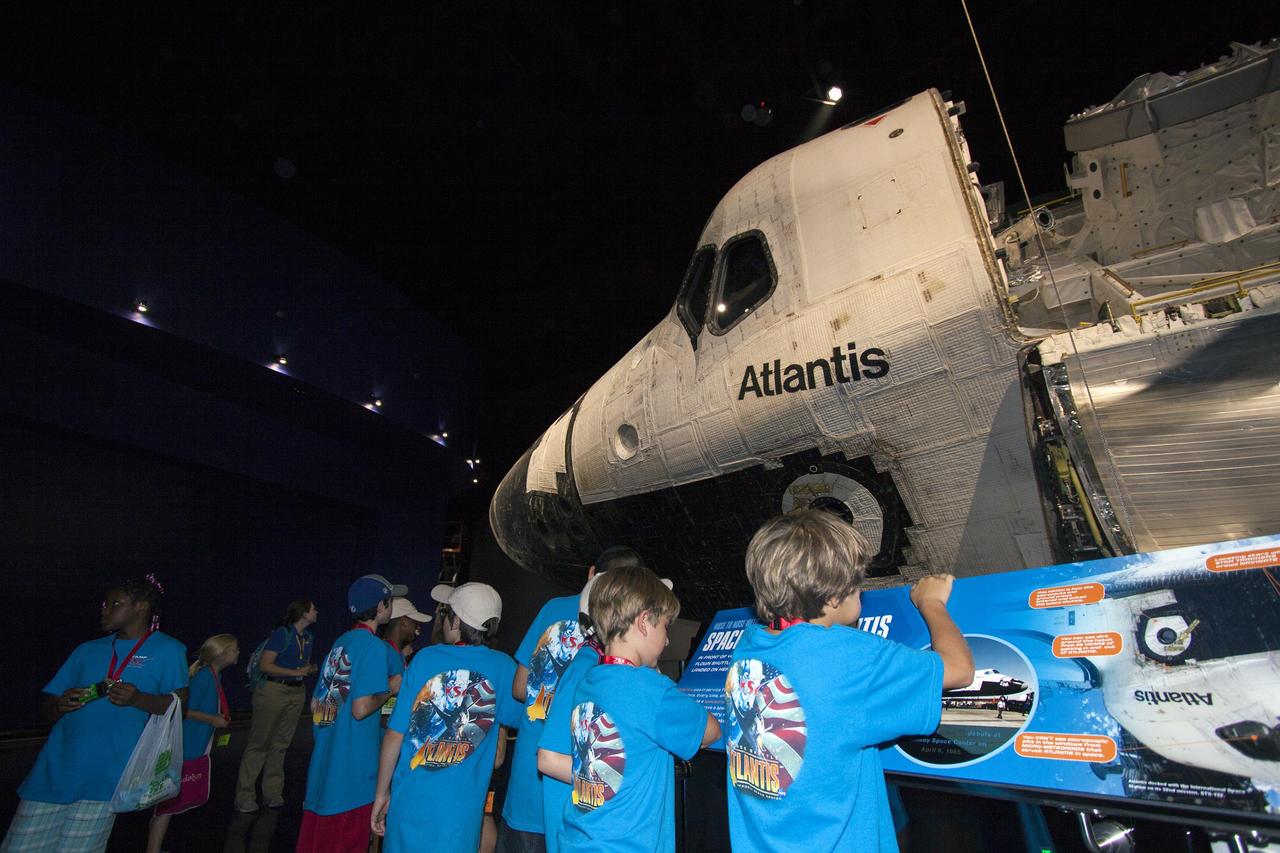 CAPE CANAVERAL, Fla. -- At the Kennedy Space Center Visitor Complex in Florida, Camp Kennedy Space Center participants get an up-close look at the space shuttle Atlantis during a weeklong summer activity for students entering second through ninth grades. Their tour took place just as final preparations were underway for the opening of the "Space Shuttle Atlantis" facility. The new $100 million facility will include interactive exhibits that tell the story of the 30-year Space Shuttle Program and highlight the future of space exploration. The "Space Shuttle Atlantis" exhibit is scheduled to open June 29, 2013.Photo credit: NASA/ Jim Grossmann