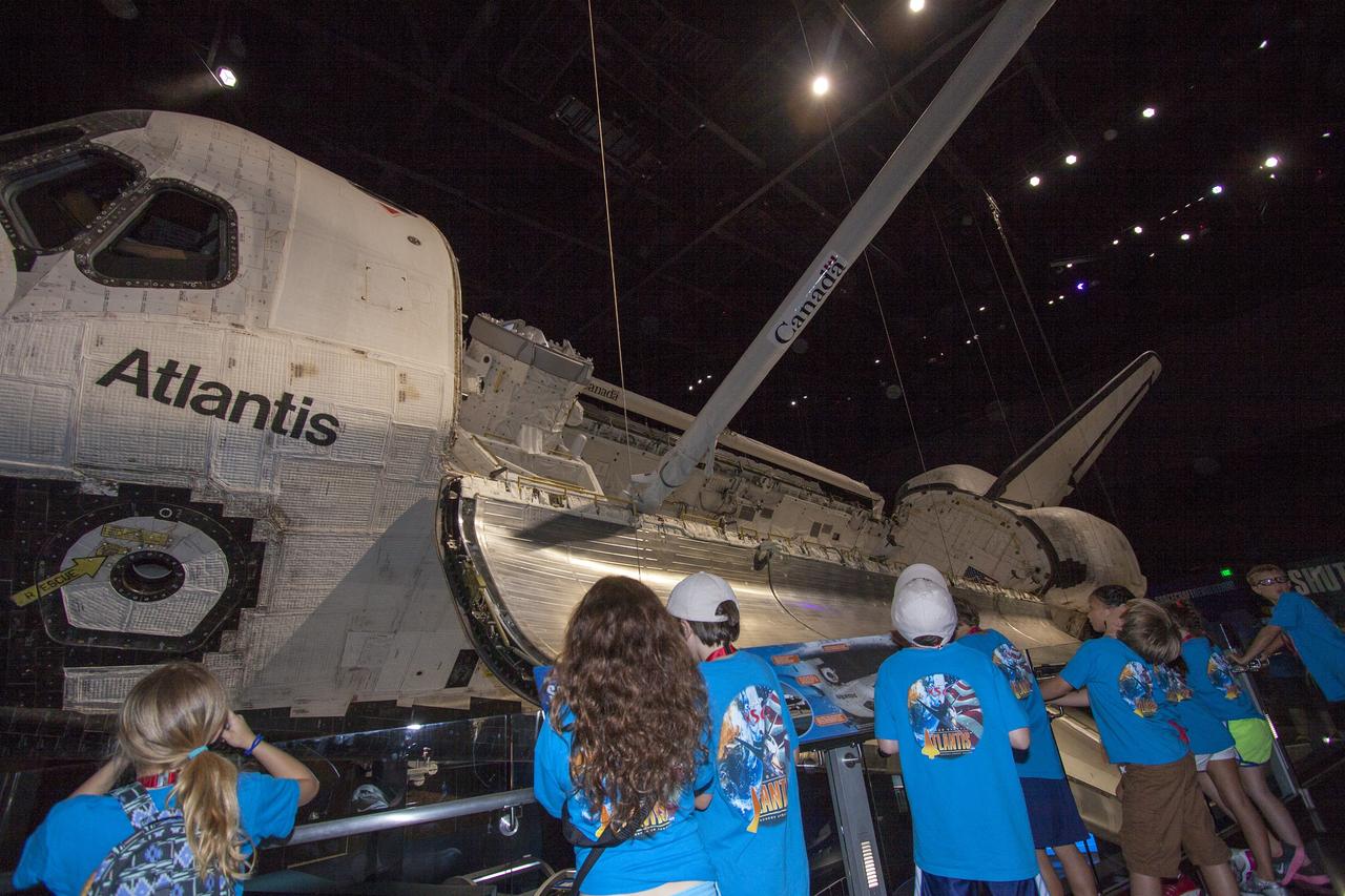 CAPE CANAVERAL, Fla. -- At the Kennedy Space Center Visitor Complex in Florida, Camp Kennedy Space Center participants get an up-close look at the space shuttle Atlantis during a weeklong summer activity for students entering second through ninth grades. Their tour took place just as final preparations were underway for the opening of the "Space Shuttle Atlantis" facility. The new $100 million facility will include interactive exhibits that tell the story of the 30-year Space Shuttle Program and highlight the future of space exploration. The "Space Shuttle Atlantis" exhibit is scheduled to open June 29, 2013.Photo credit: NASA/ Jim Grossmann