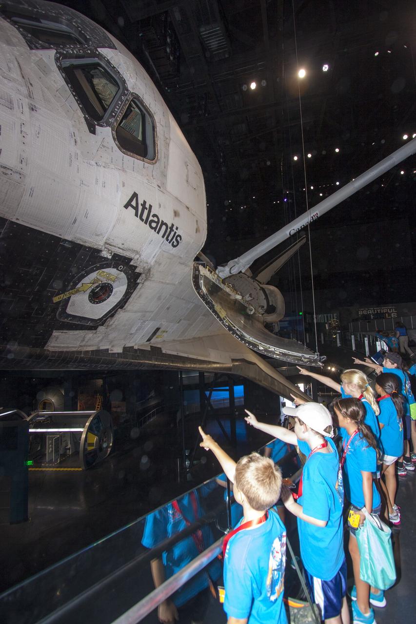 CAPE CANAVERAL, Fla. -- At the Kennedy Space Center Visitor Complex in Florida, Camp Kennedy Space Center participants get an up-close look at the space shuttle Atlantis during a weeklong summer activity for students entering second through ninth grades. Their tour took place just as final preparations were underway for the opening of the "Space Shuttle Atlantis" facility. The new $100 million facility will include interactive exhibits that tell the story of the 30-year Space Shuttle Program and highlight the future of space exploration. The "Space Shuttle Atlantis" exhibit is scheduled to open June 29, 2013.Photo credit: NASA/ Jim Grossmann