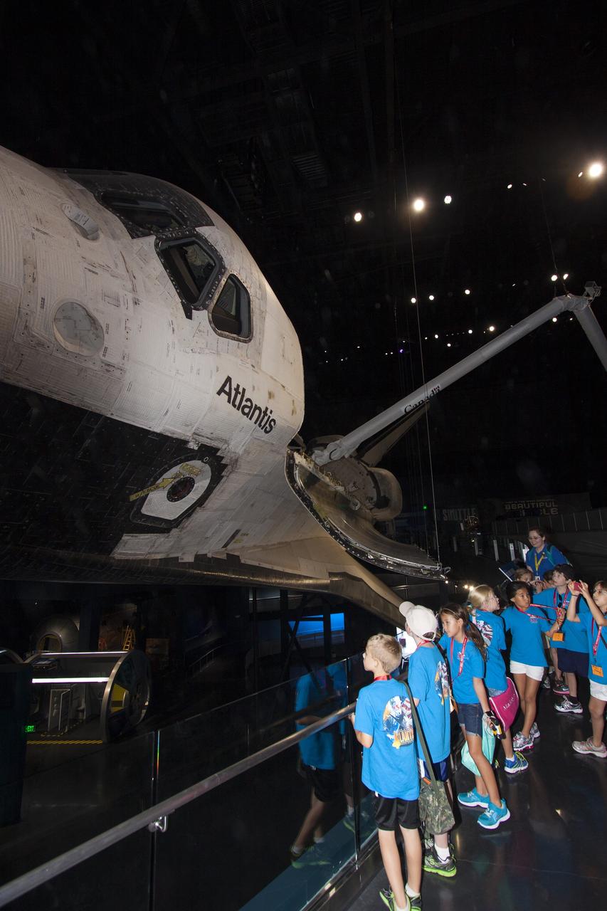 CAPE CANAVERAL, Fla. -- At the Kennedy Space Center Visitor Complex in Florida, Camp Kennedy Space Center participants get an up-close look at the space shuttle Atlantis during a weeklong summer activity for students entering second through ninth grades. Their tour took place just as final preparations were underway for the opening of the "Space Shuttle Atlantis" facility. The new $100 million facility will include interactive exhibits that tell the story of the 30-year Space Shuttle Program and highlight the future of space exploration. The "Space Shuttle Atlantis" exhibit is scheduled to open June 29, 2013.Photo credit: NASA/ Jim Grossmann