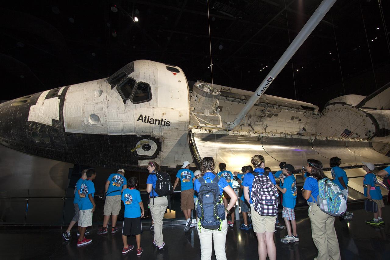 CAPE CANAVERAL, Fla. -- At the Kennedy Space Center Visitor Complex in Florida, Camp Kennedy Space Center participants get an up-close look at the space shuttle Atlantis during a weeklong summer activity for students entering second through ninth grades. Their tour took place just as final preparations were underway for the opening of the "Space Shuttle Atlantis" facility. The new $100 million facility will include interactive exhibits that tell the story of the 30-year Space Shuttle Program and highlight the future of space exploration. The "Space Shuttle Atlantis" exhibit is scheduled to open June 29, 2013.Photo credit: NASA/ Jim Grossmann